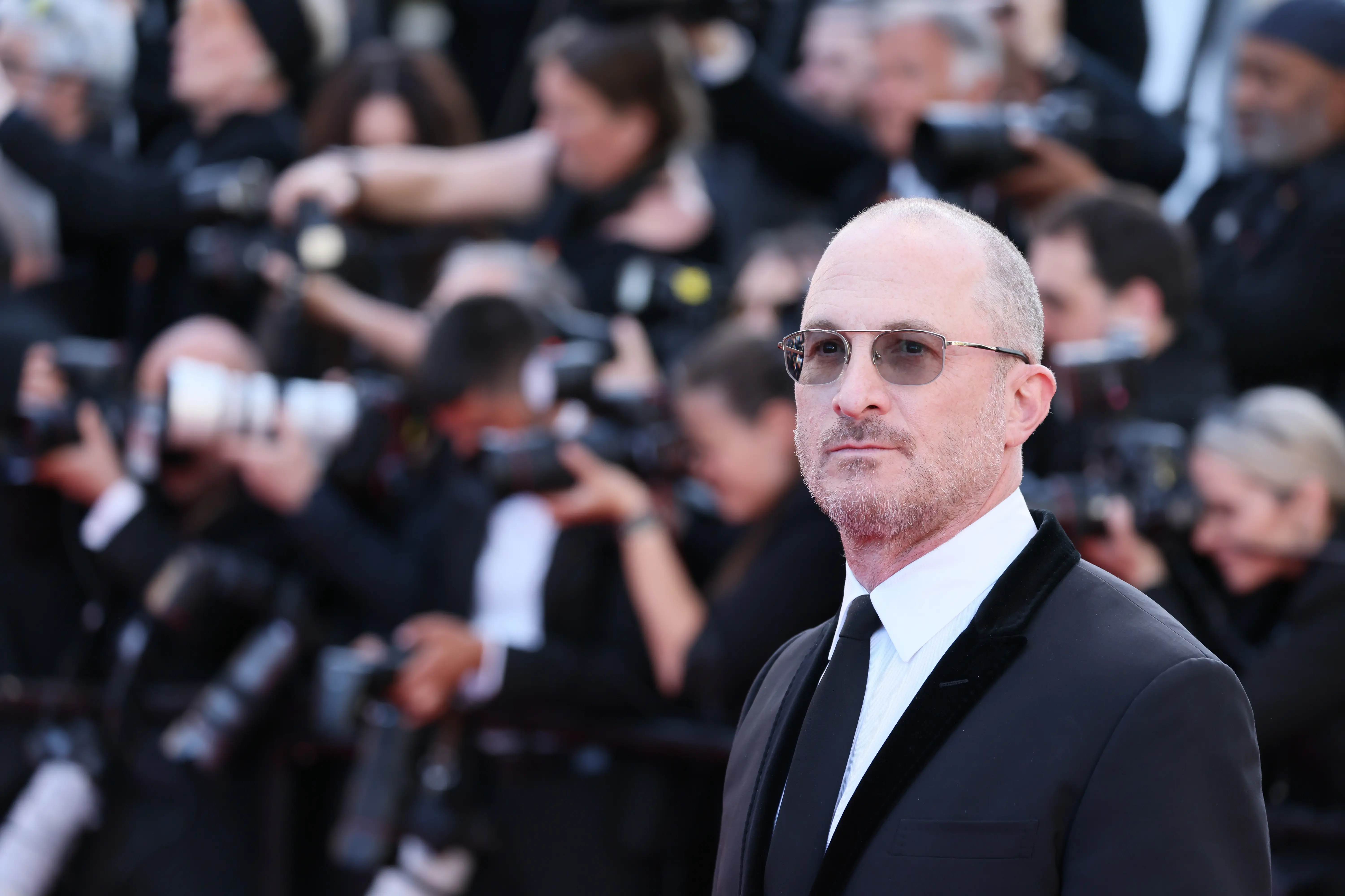 Darren Aronofsky in a black suit and tie