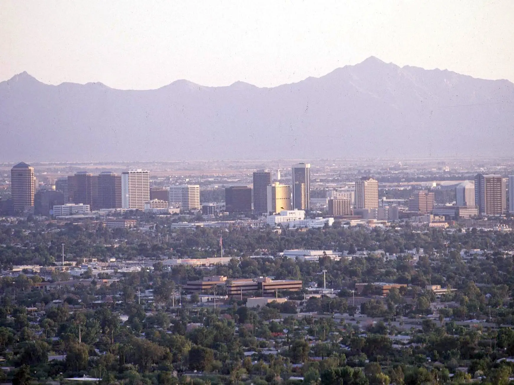 A city with a mountain in the background.