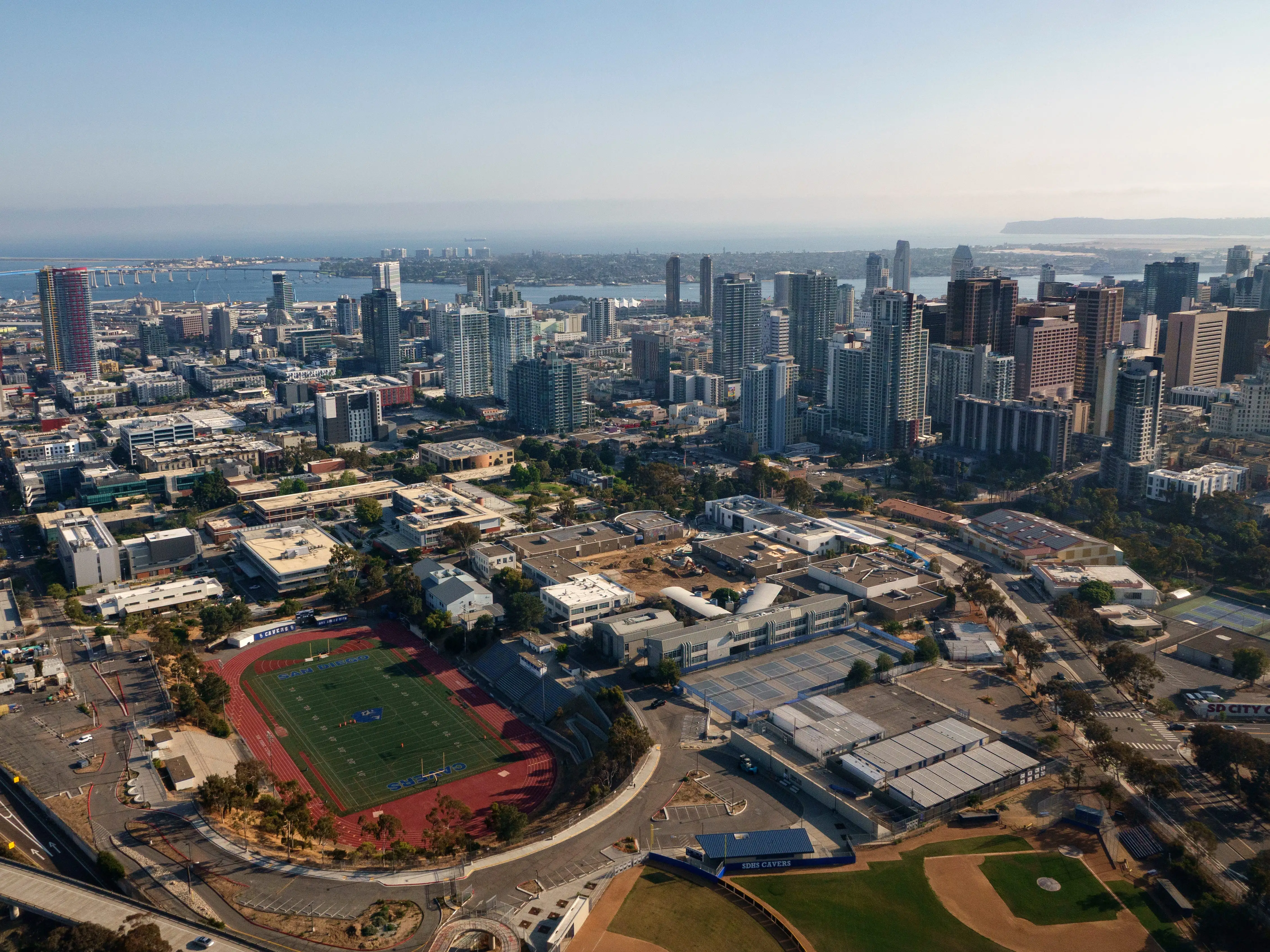 An aerial view of a city, with the ocean in the background.