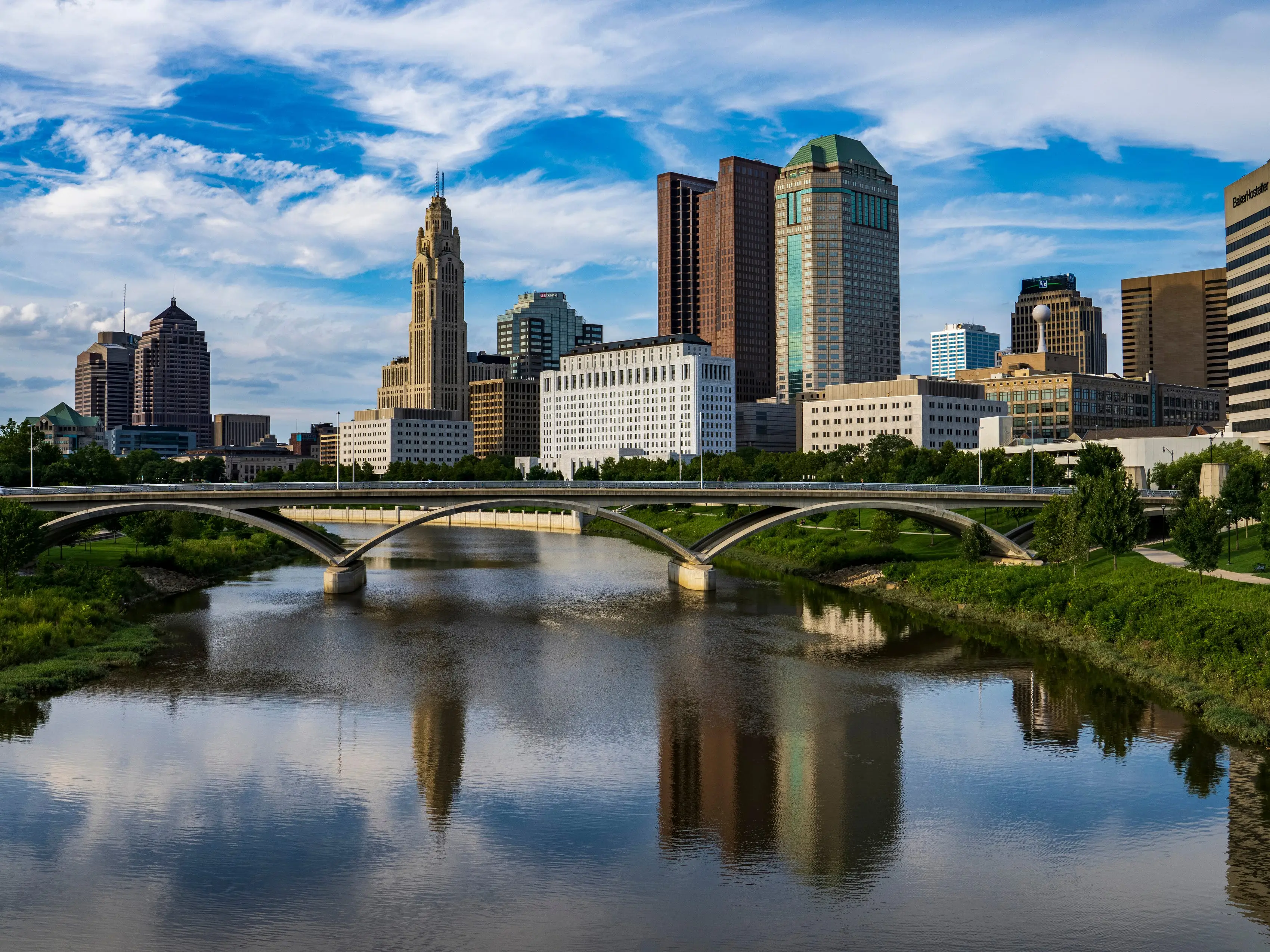A view of a city skyline with a bridge in the foreground.