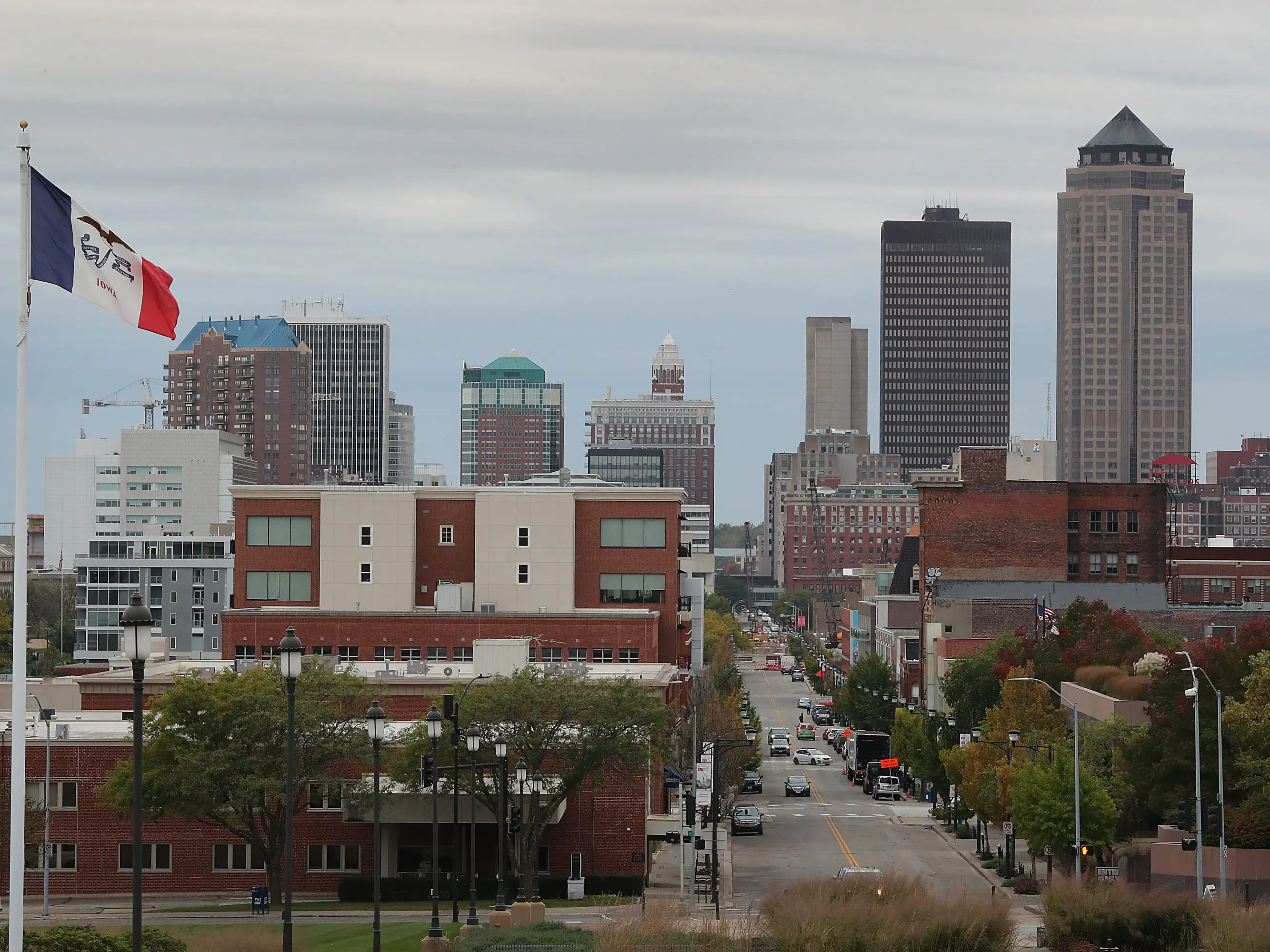 A photo of a city skyline with a flag in the foreground.