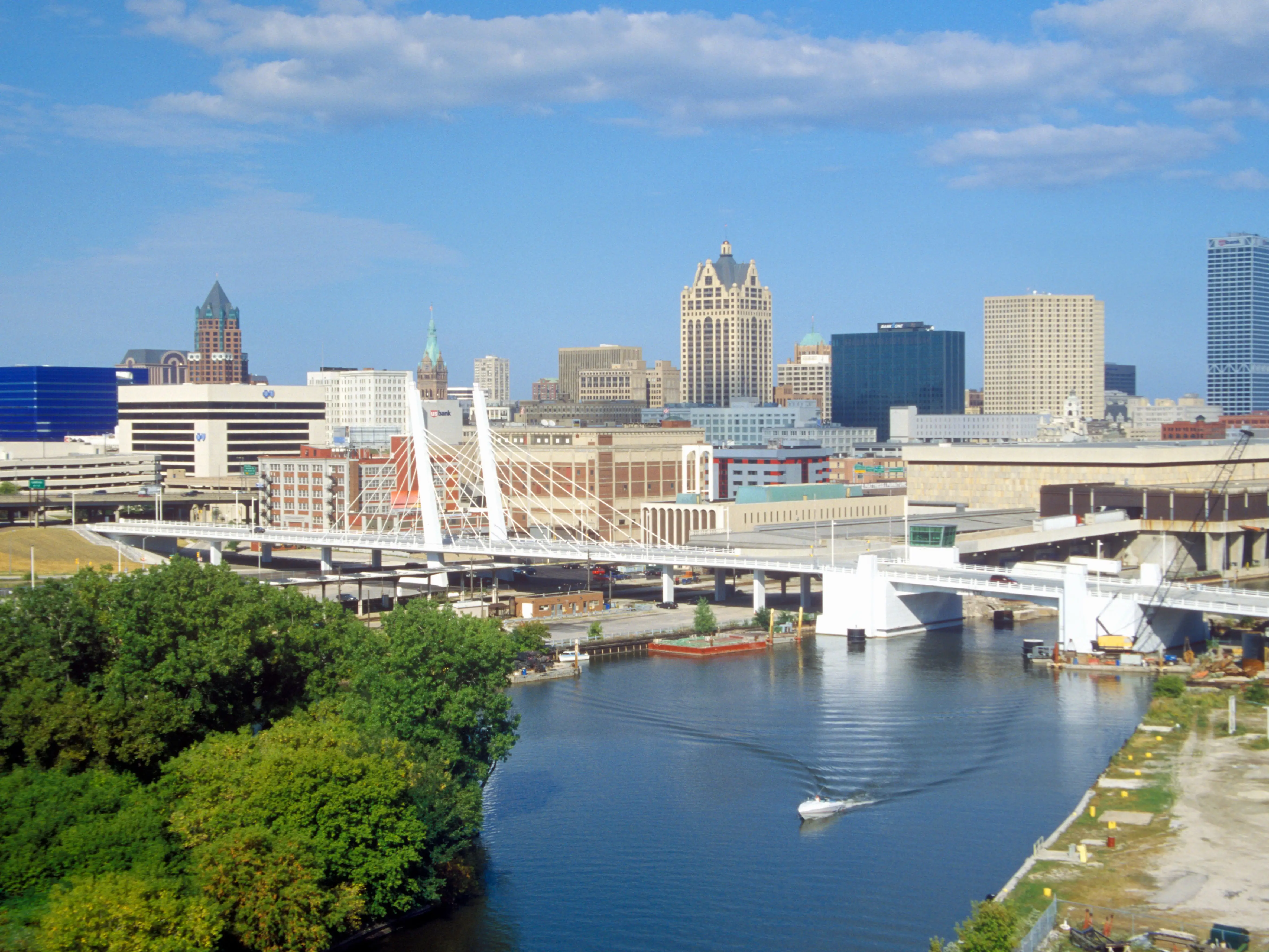 A city skyline with a river in the foreground.