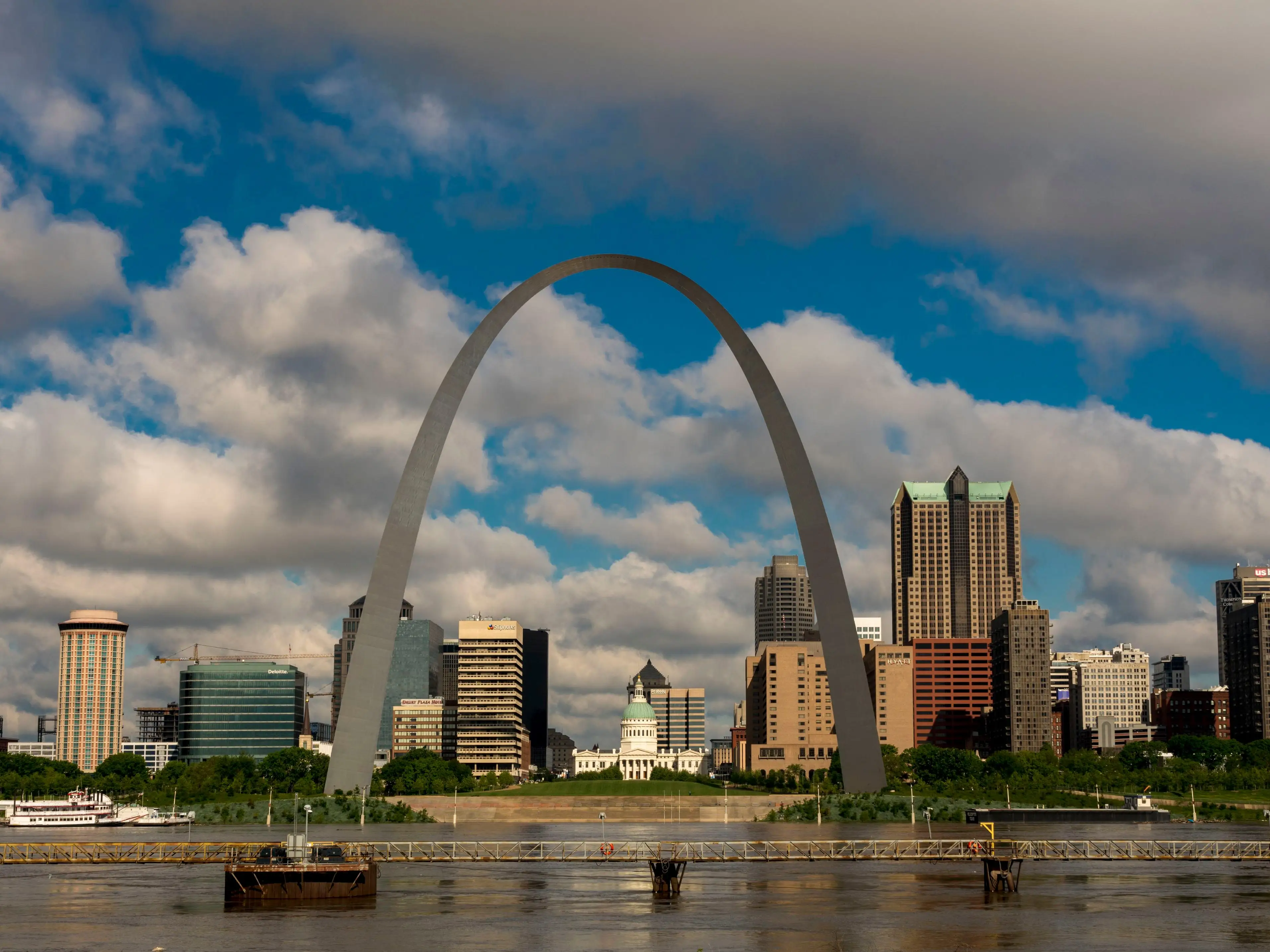 A photo of a city skyline with a river in the foreground.