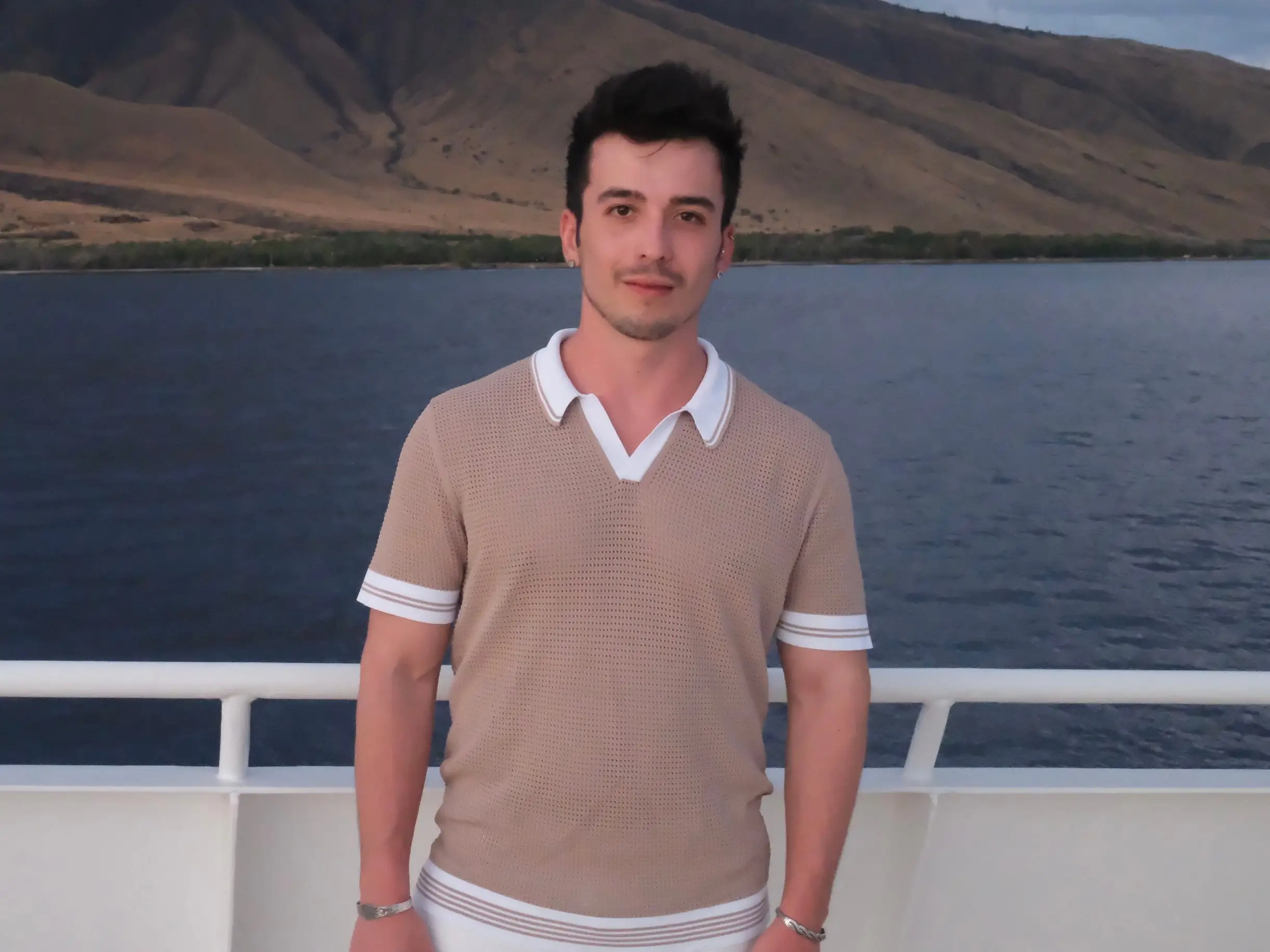 Jamie valentino on a boat with water behind him