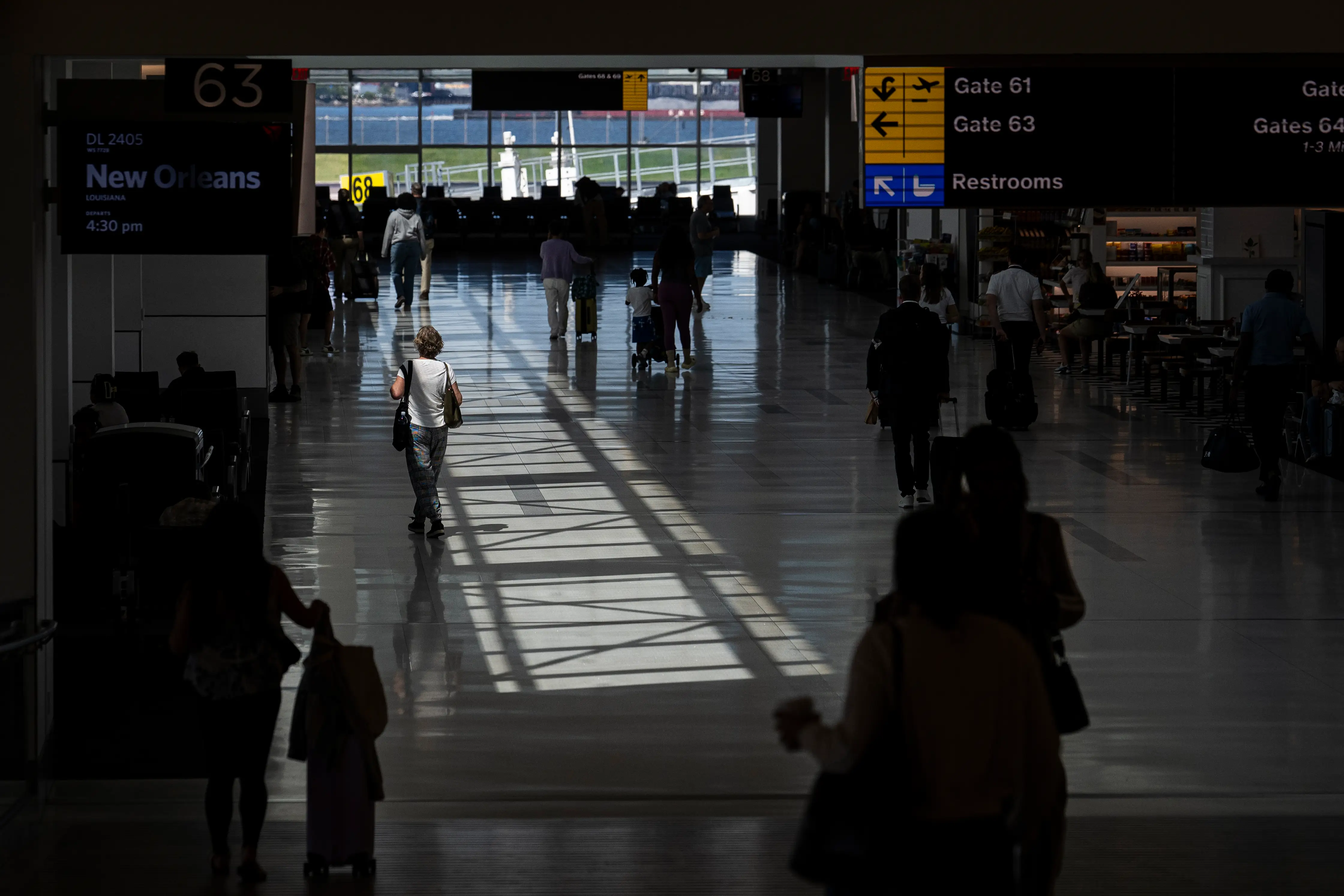 Passengers walk through the terminal at LaGuardia Airport.