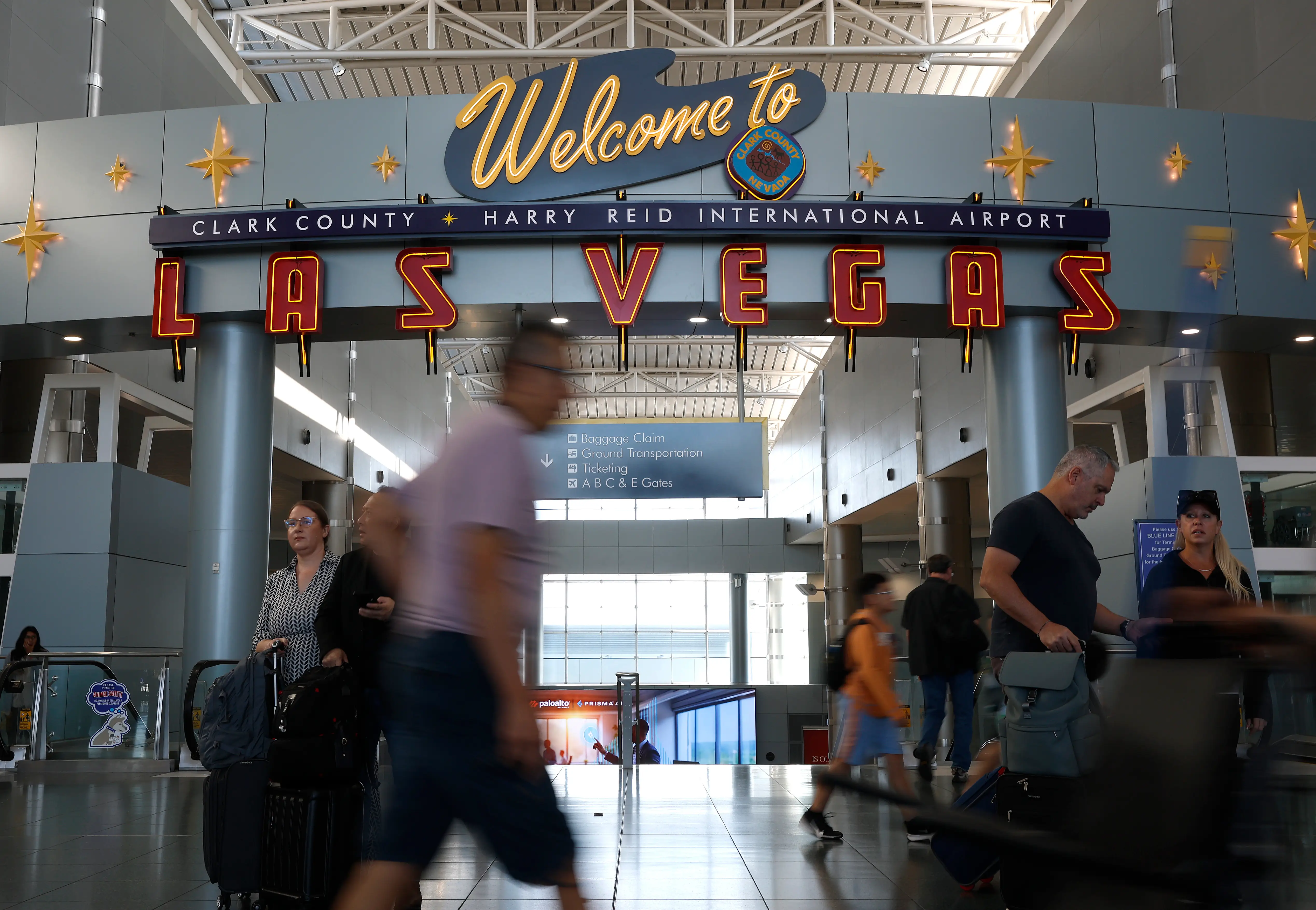 Travelers walk through a terminal at Harry Reid International Airport in Las Vegas, Nevada.