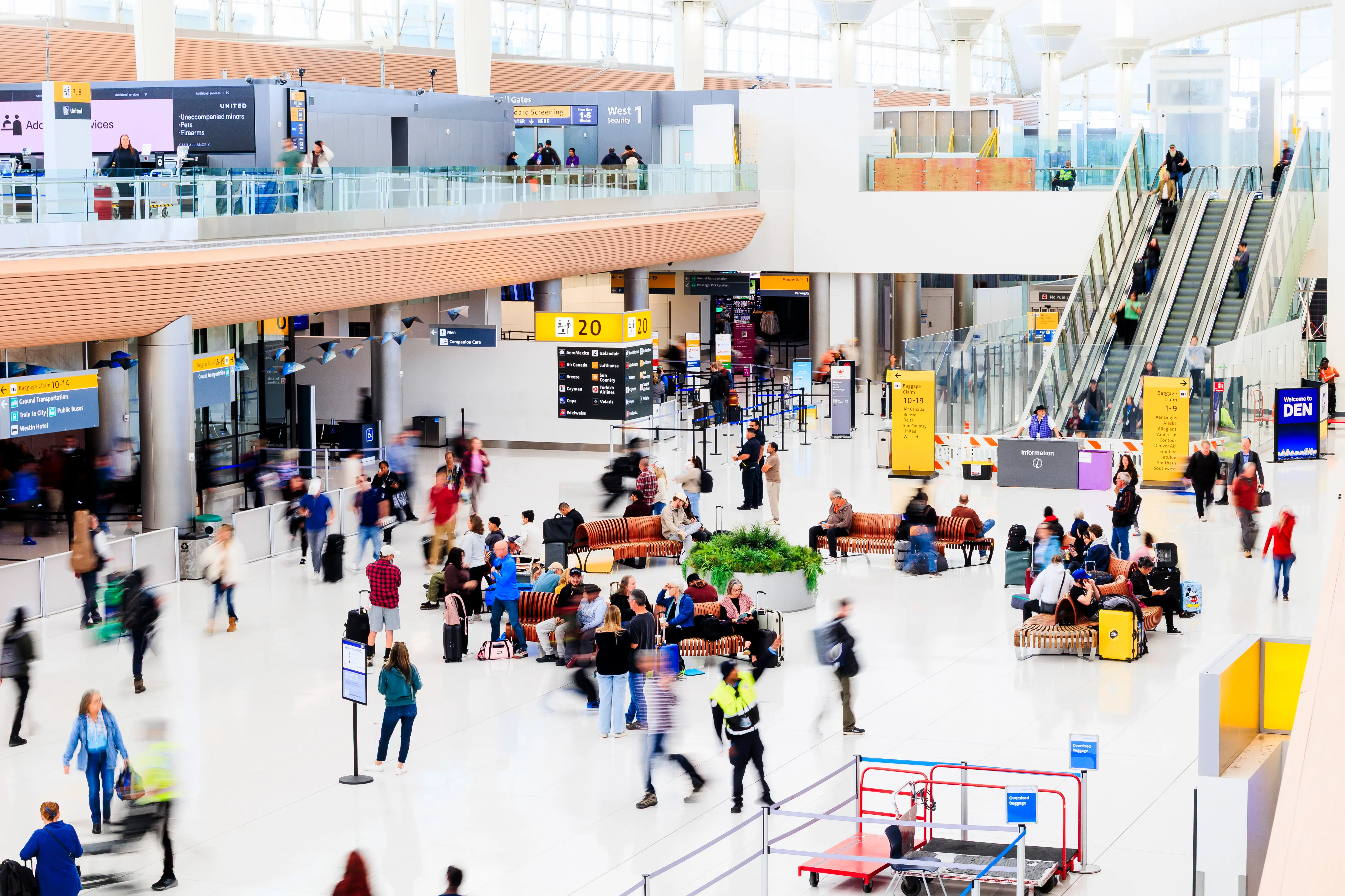 People walking through Denver International Airport.