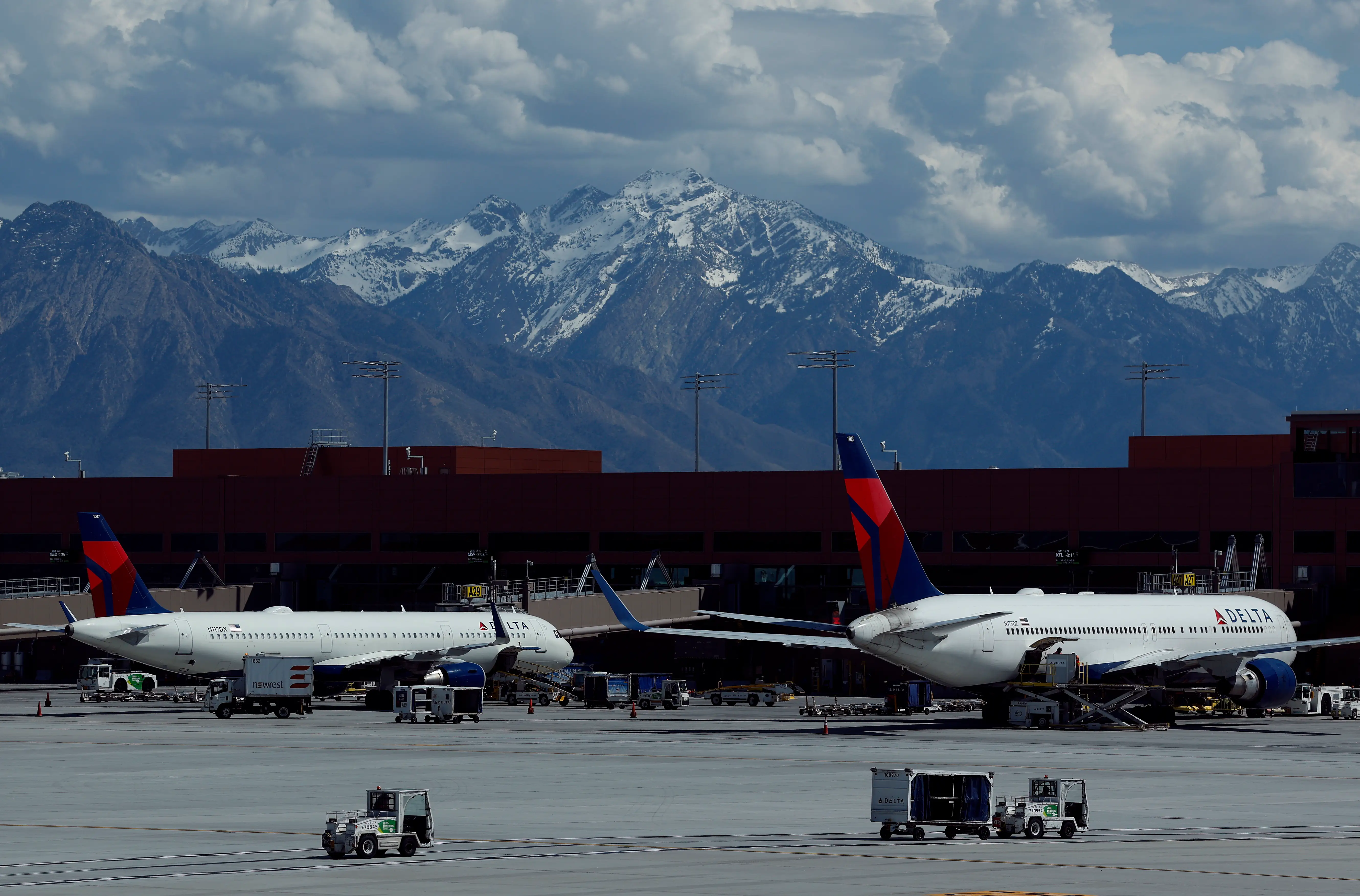 Delta Airlines planes sit parked at the gate at Salt Lake City International Airport.