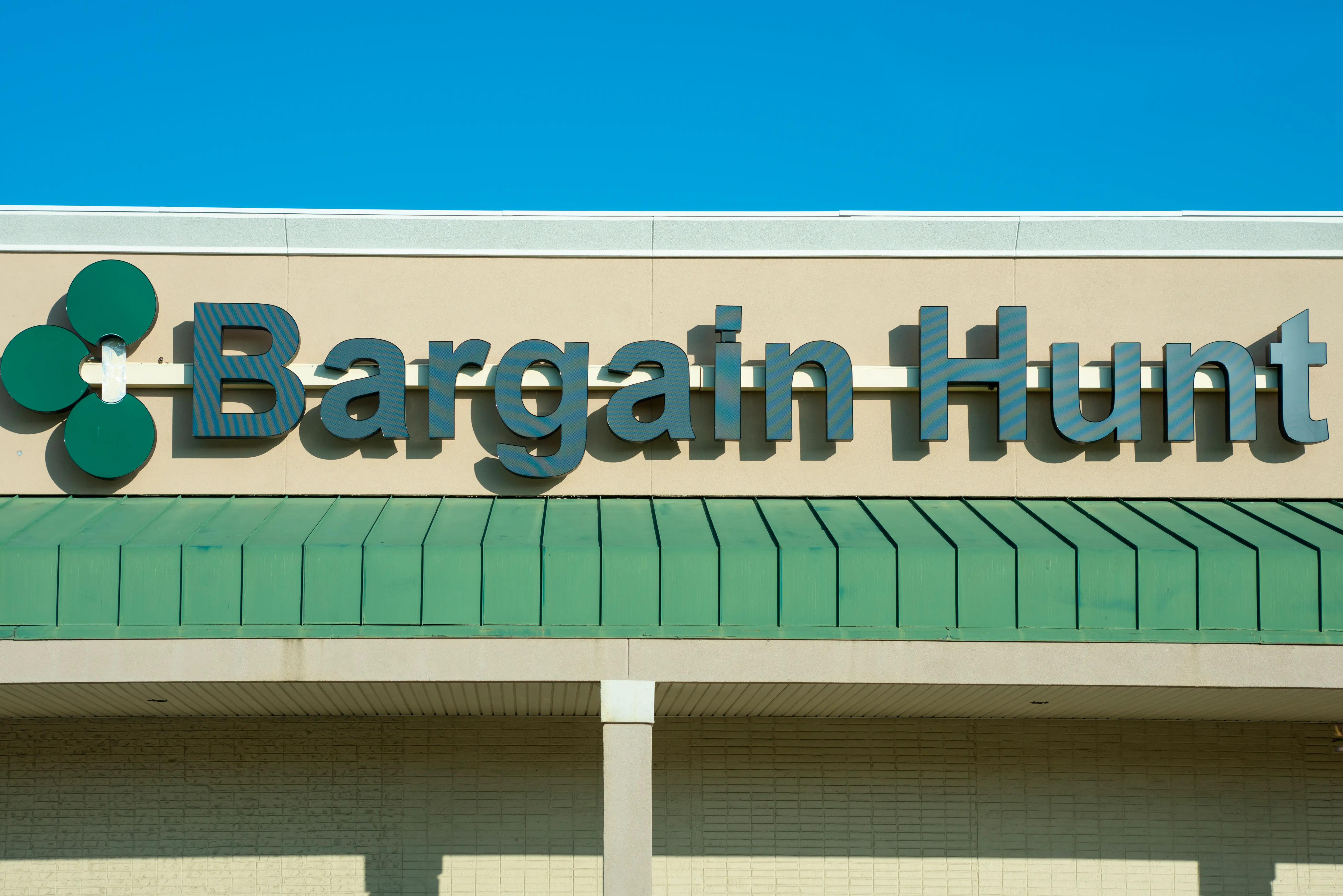 Outside sign for Bargain Hunt discount retail store.