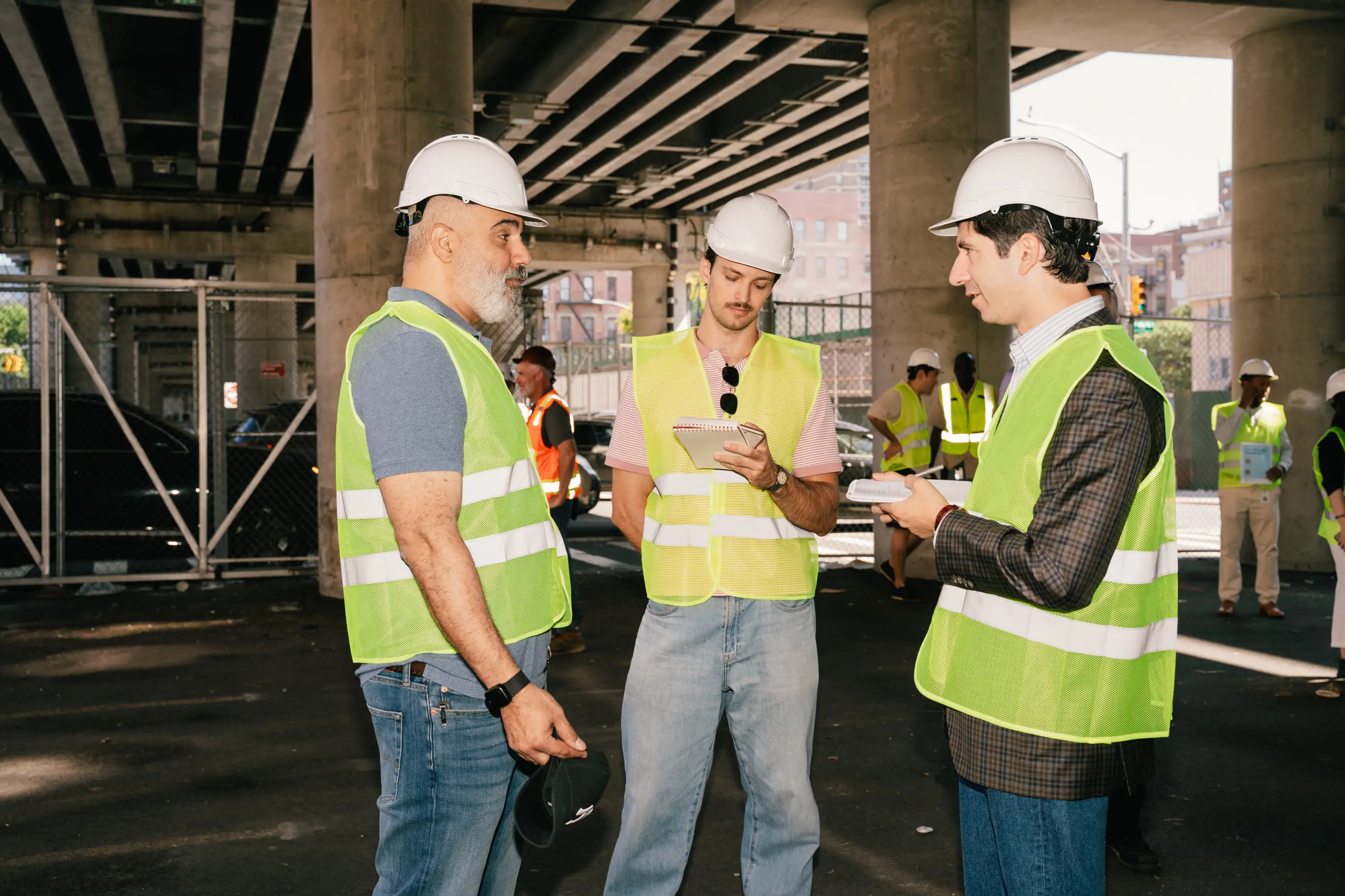 Reporters and prospective operators tour a vacant lot under a highway overpass in East Harlem that is slated to become one of New York City's first municipal grocery stores in New York