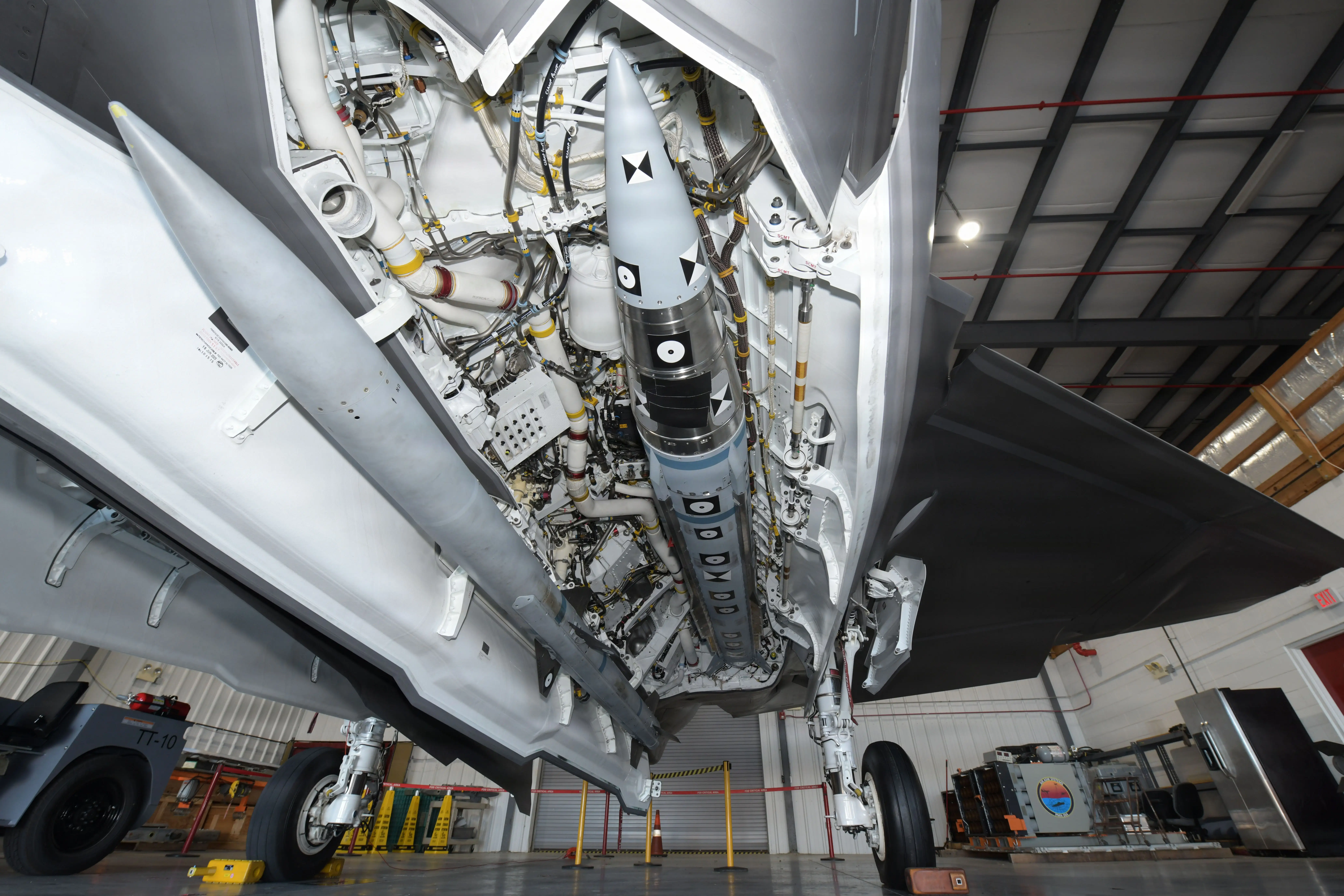 An AIM-424 Long Range Air-to-Air Missile (LRAAM) is mounted in the internal weapons bay of an F-35C, with an AIM-120 Advanced Medium Range Air-to-Air Missile (AMRAAM) mounted on the weapon bay door.