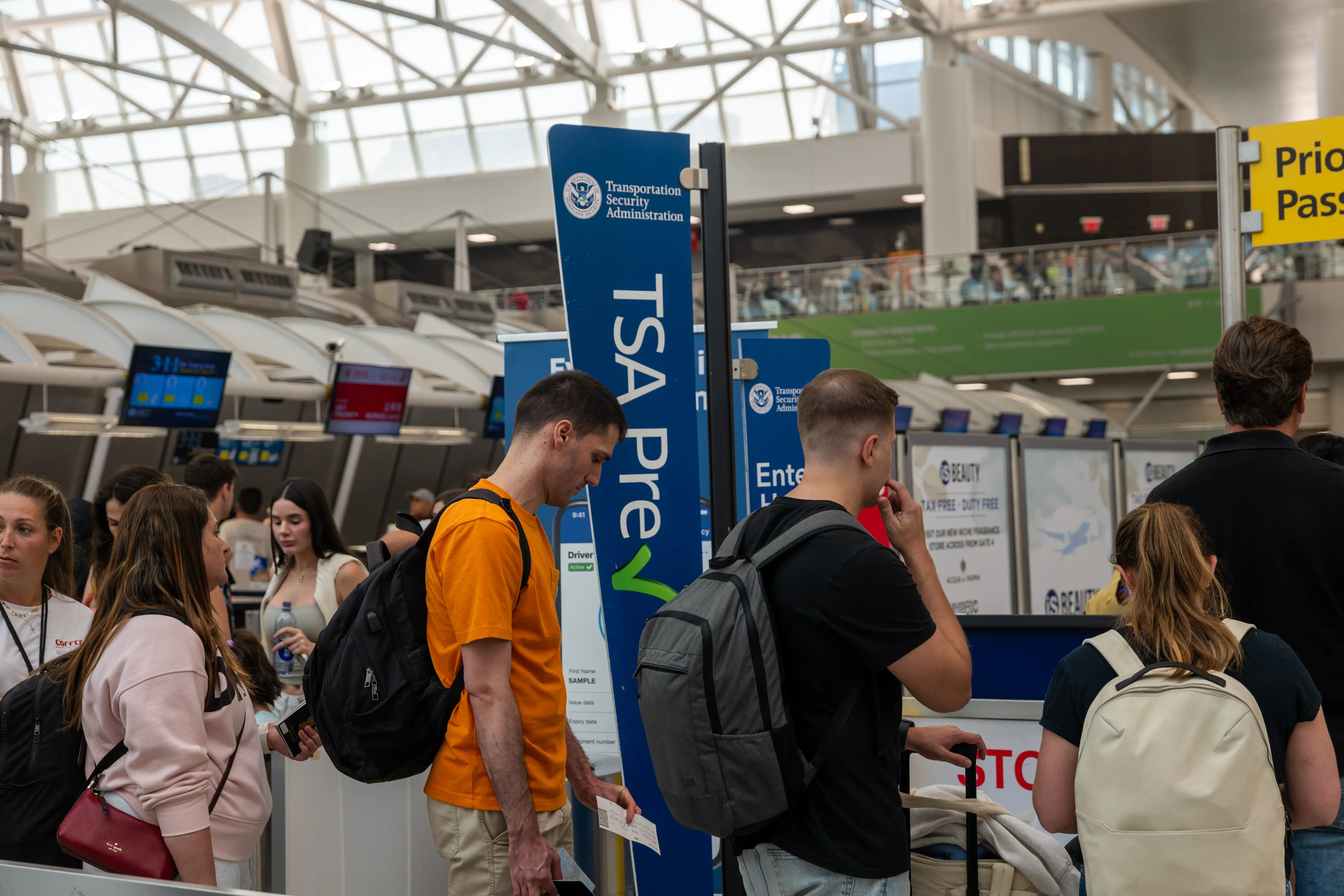 People waiting at a TSA PreCheck line.