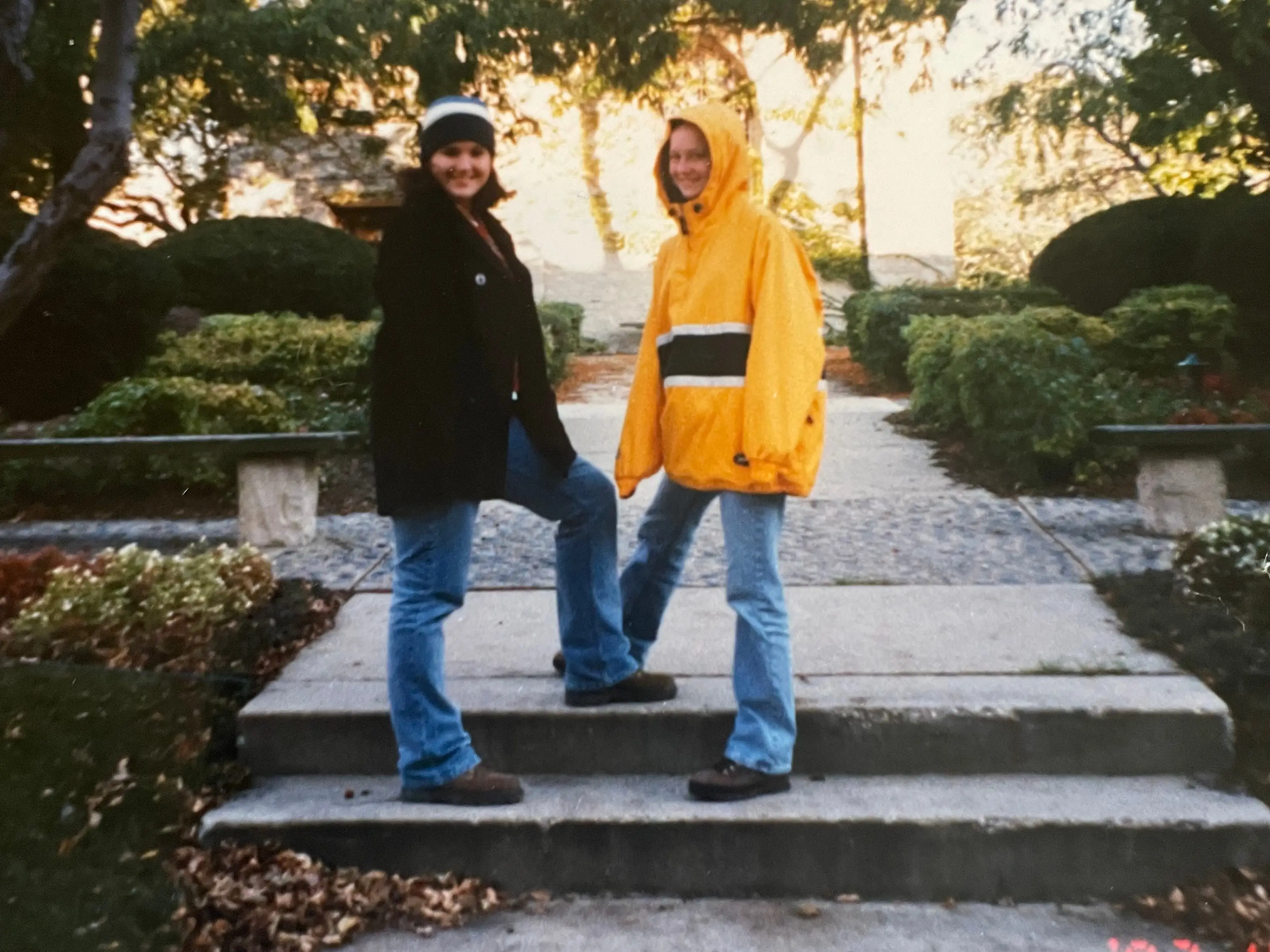 Photo of a photo of two teens in jackets posing on steps