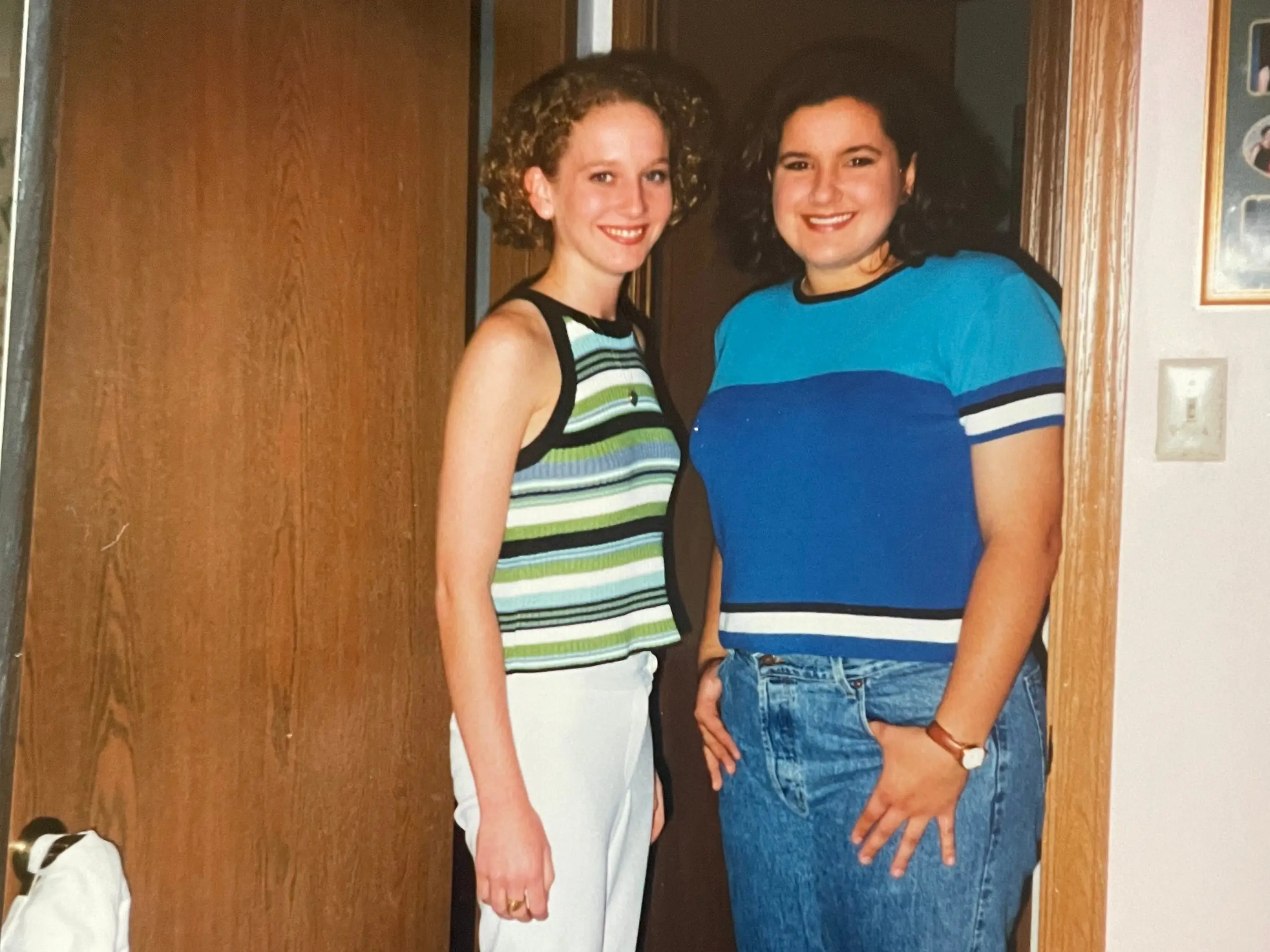 Photo of two women smiling in a doorway