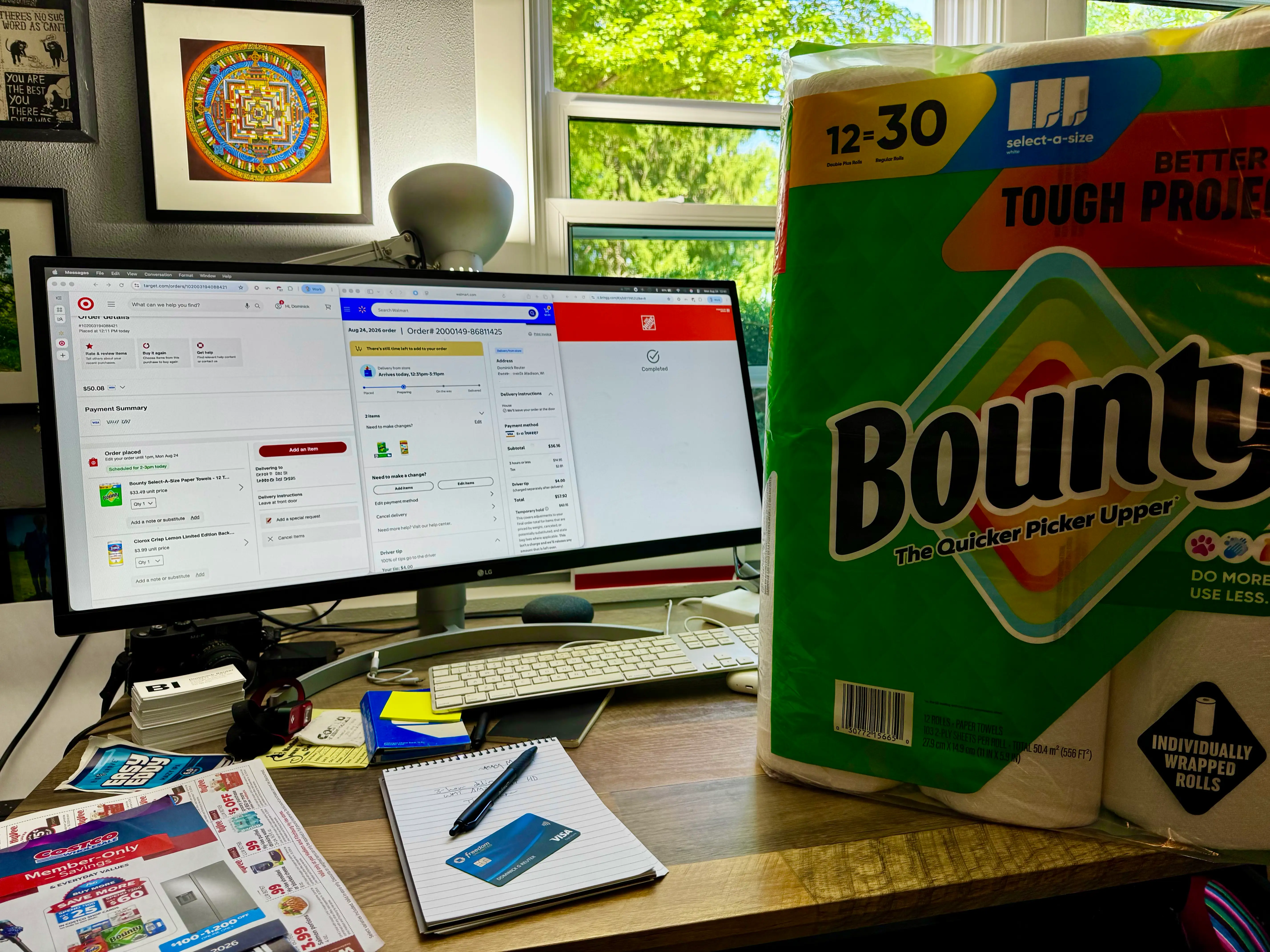 A pack of paper towels next to a computer screen.
