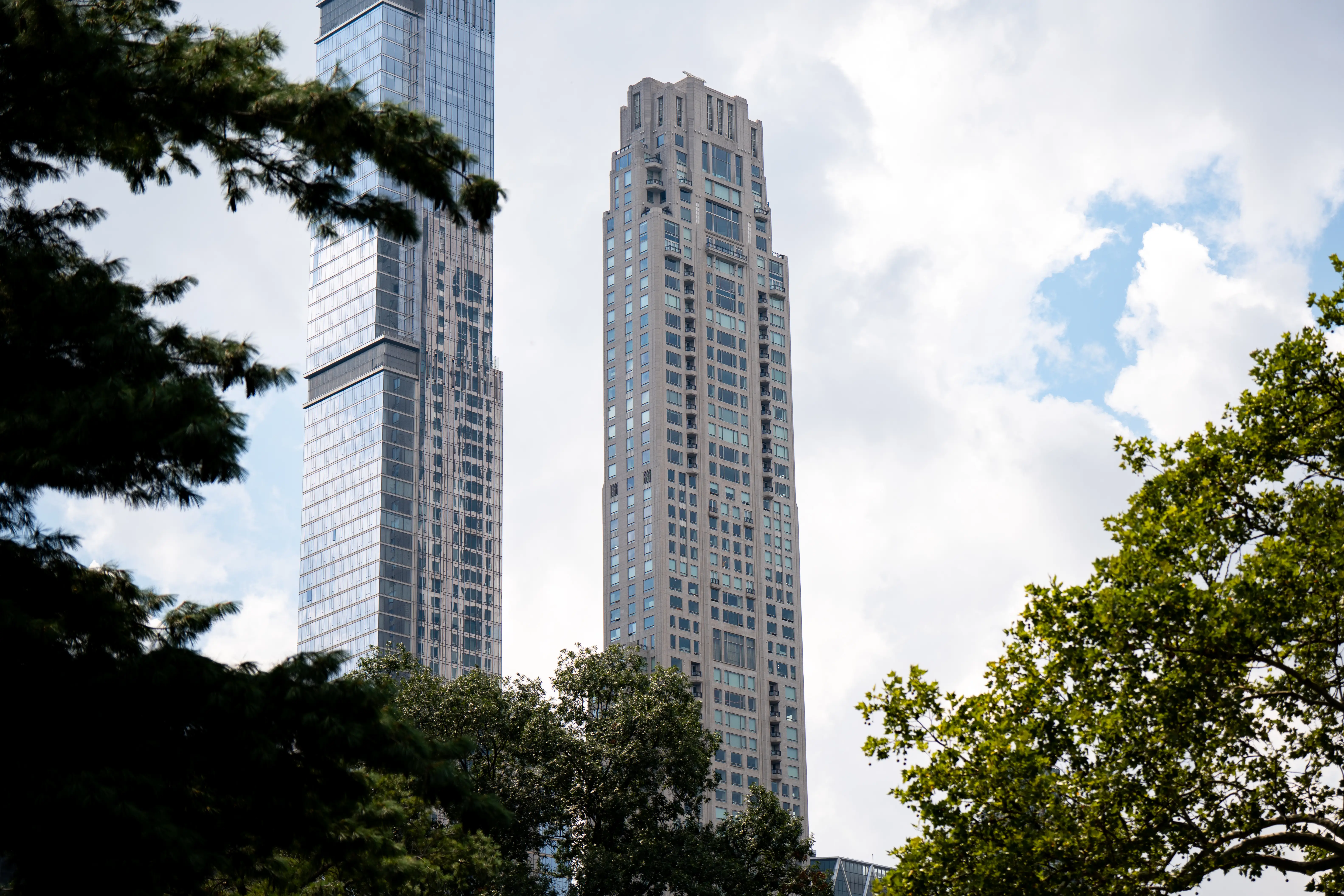 The 70-story condo building at 220 Central Park South towers above a row of trees.
