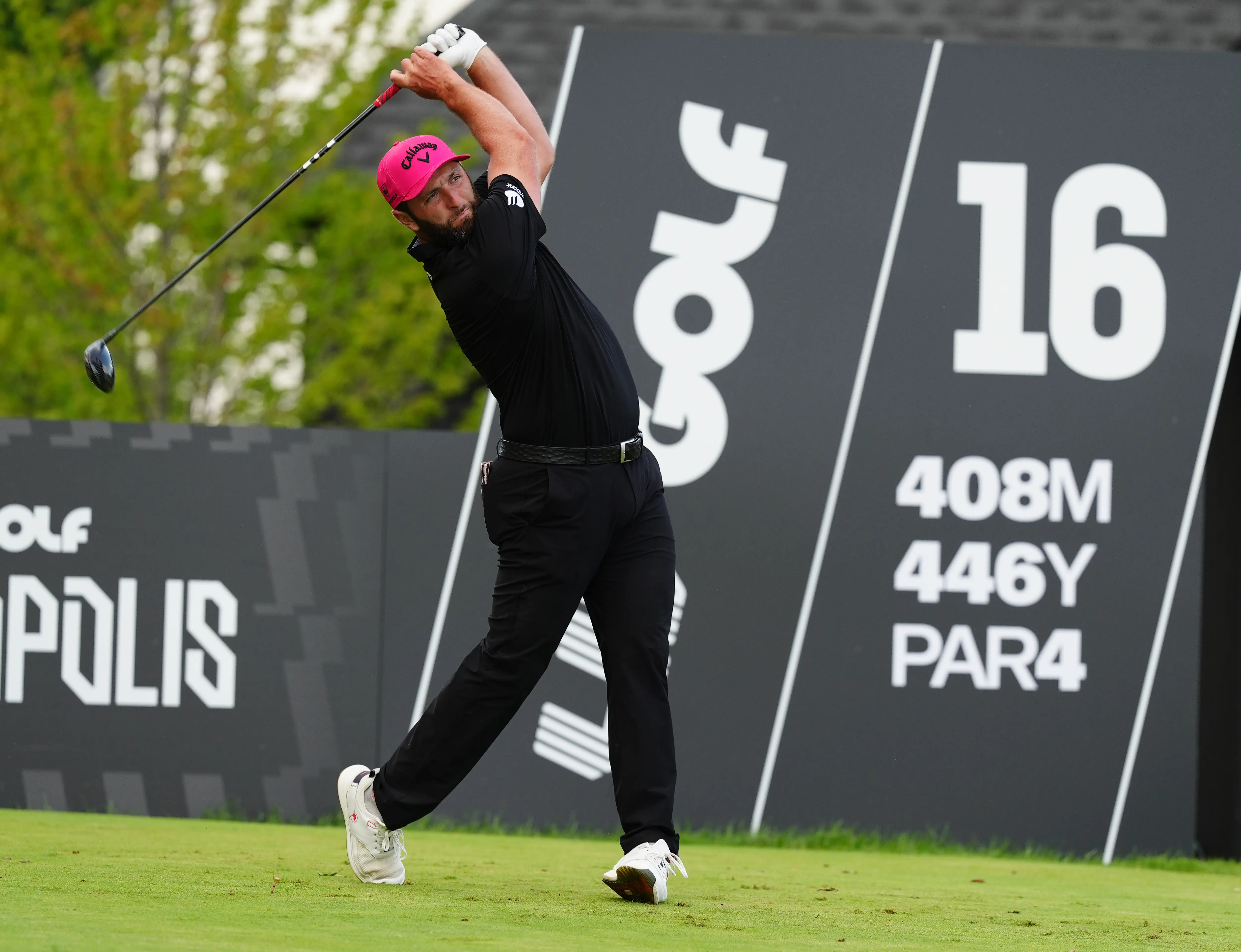 Golfer Jon Rahm hits a shot