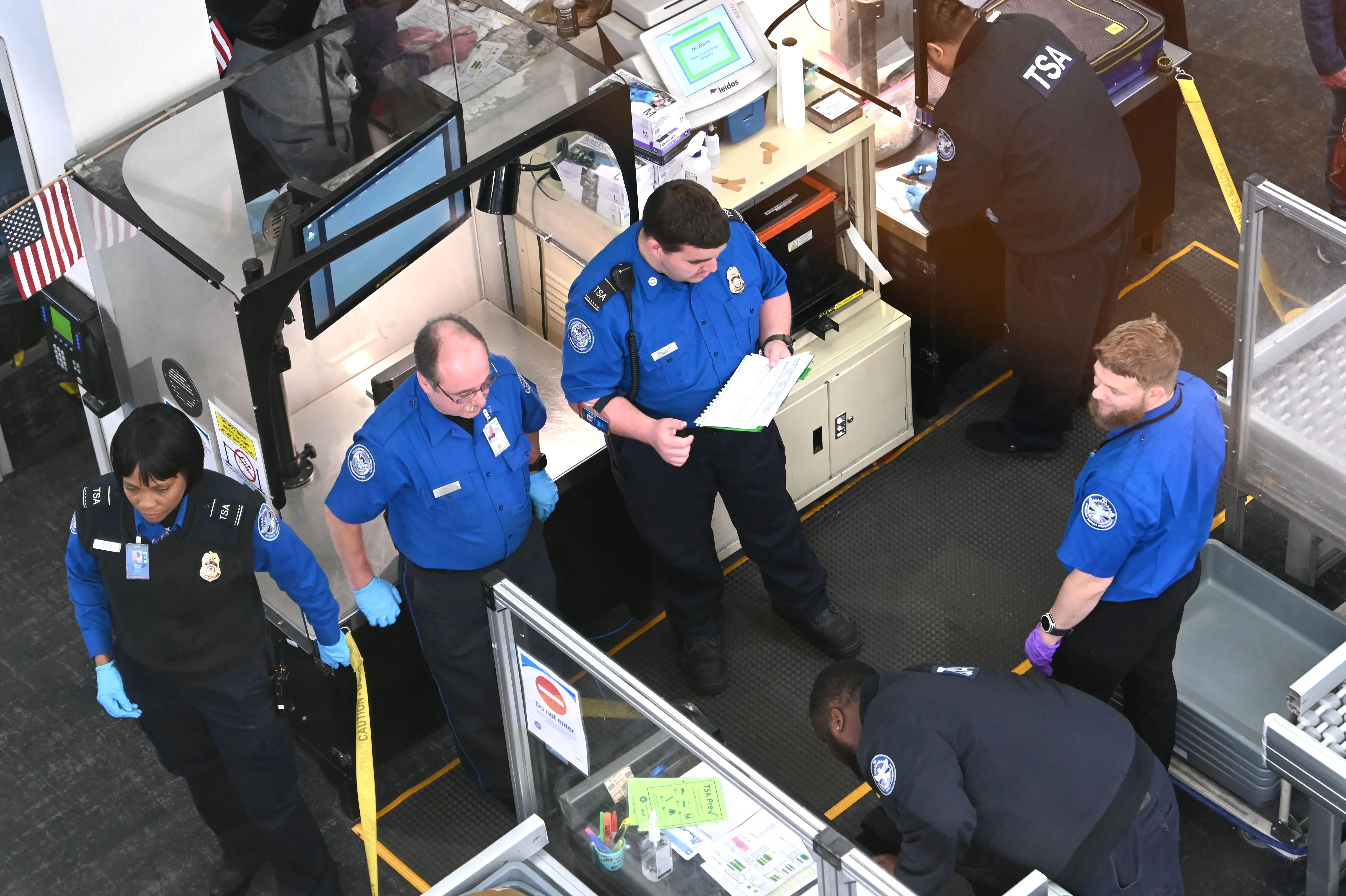 Transportation Security Administration (TSA) workers are seen working at the security checkpoint at Albany International Airport on Thursday, Oct. 30, 2025, in Albany, N.Y.