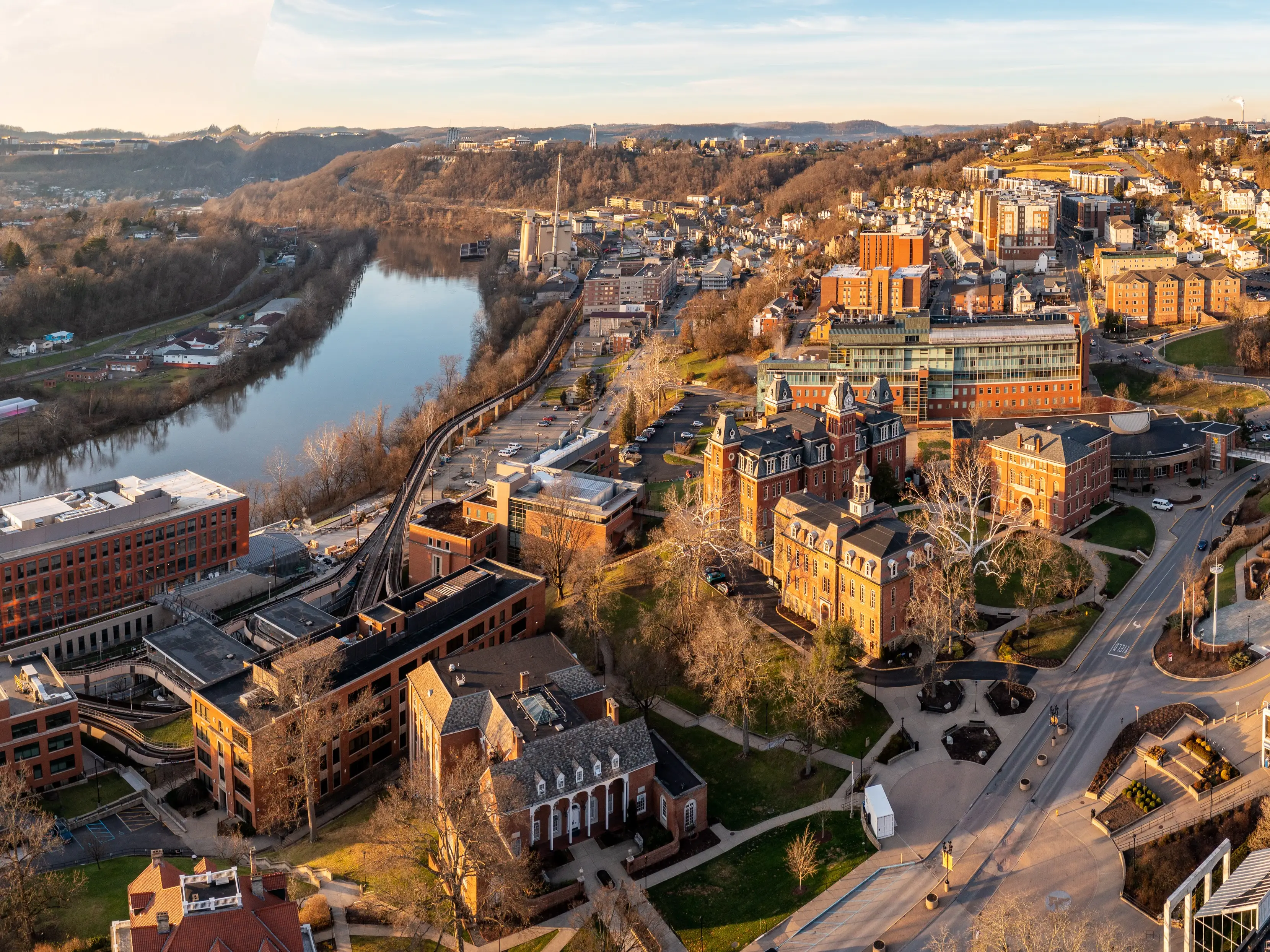 Aerial drone panoramic shot of the downtown campus of WVU in Morgantown West Virginia showing the river in the distance