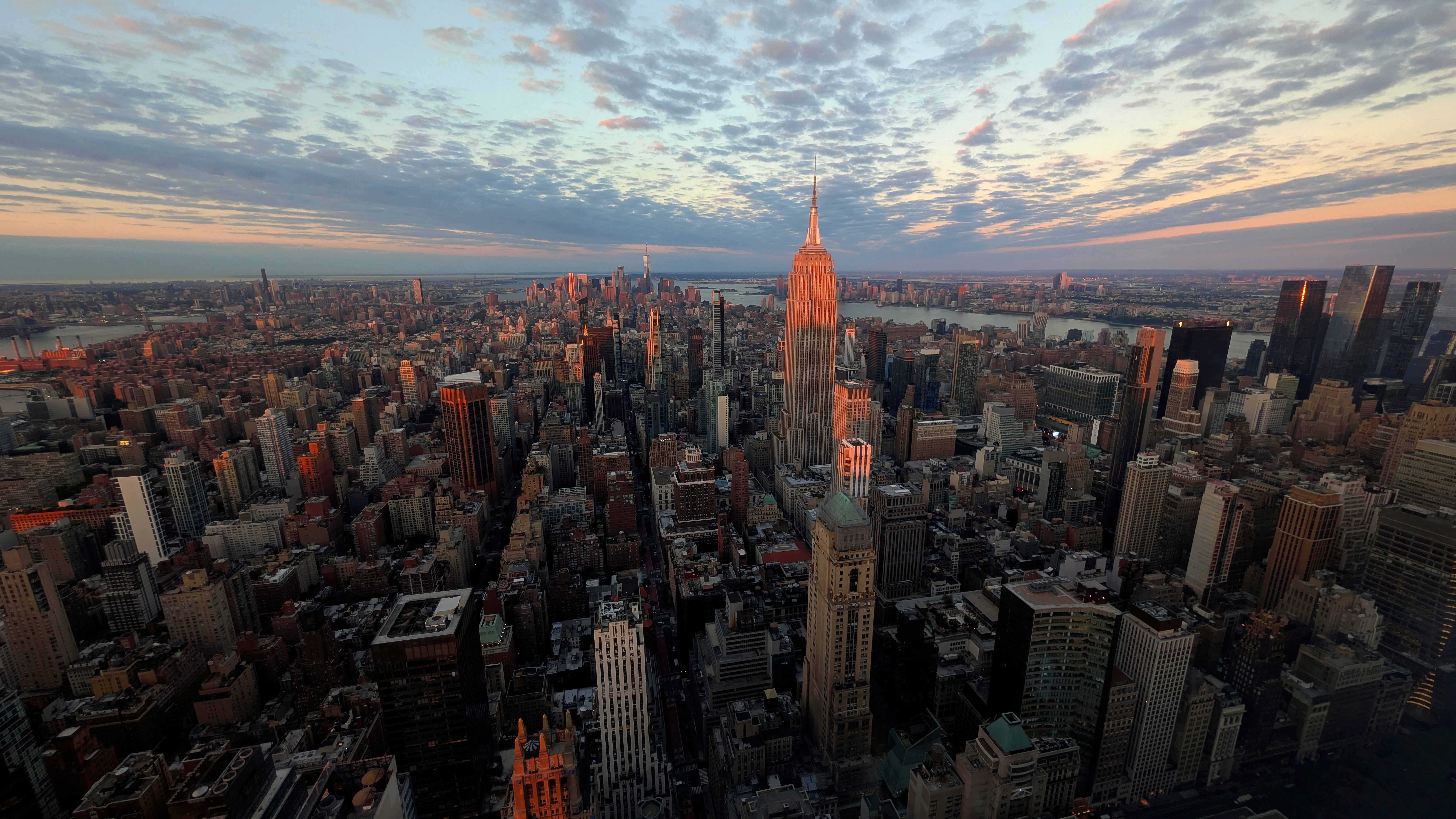 The sun rises over the Empire State Building and surrounding skyline in Manhattan