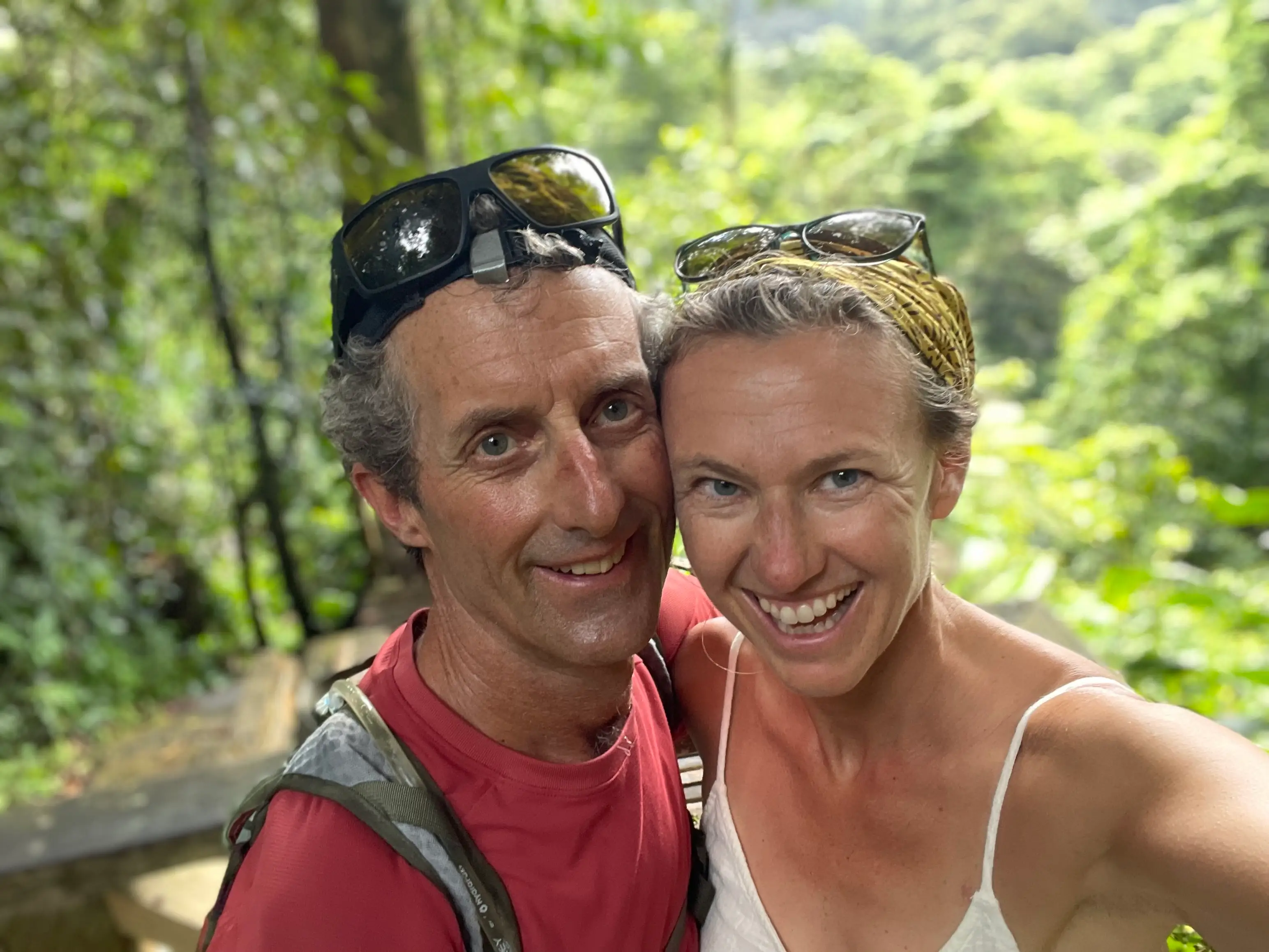The author and her husband pose in a wooded area.