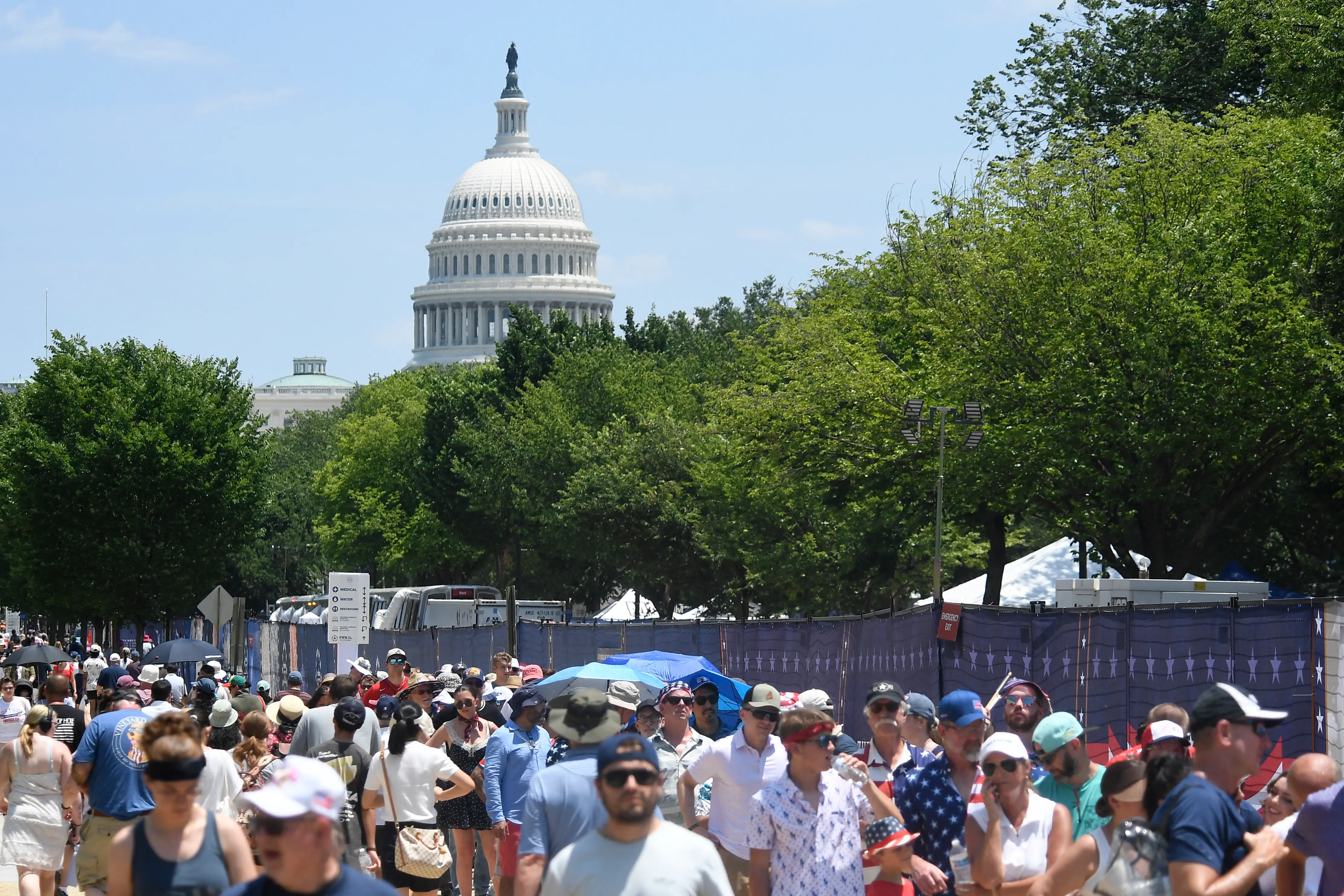 People walk in front of the US Capitol.