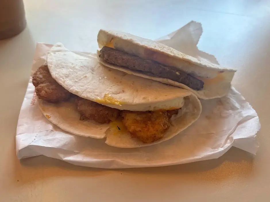 Two Wake-up wraps from Dunkin on a table — one with sausage and one with hash browns.