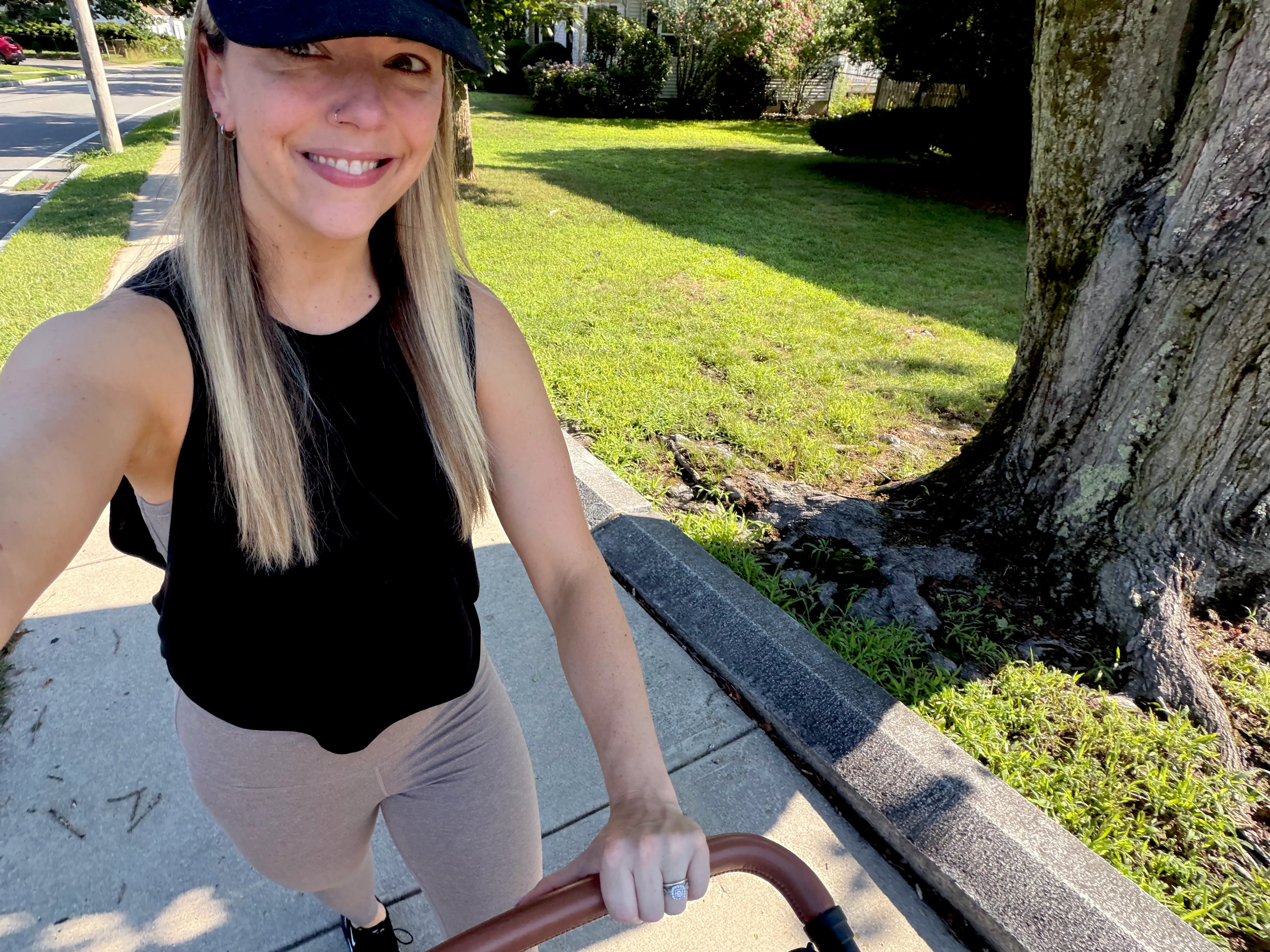 Rebecca pushes a baby stroller on a walk.