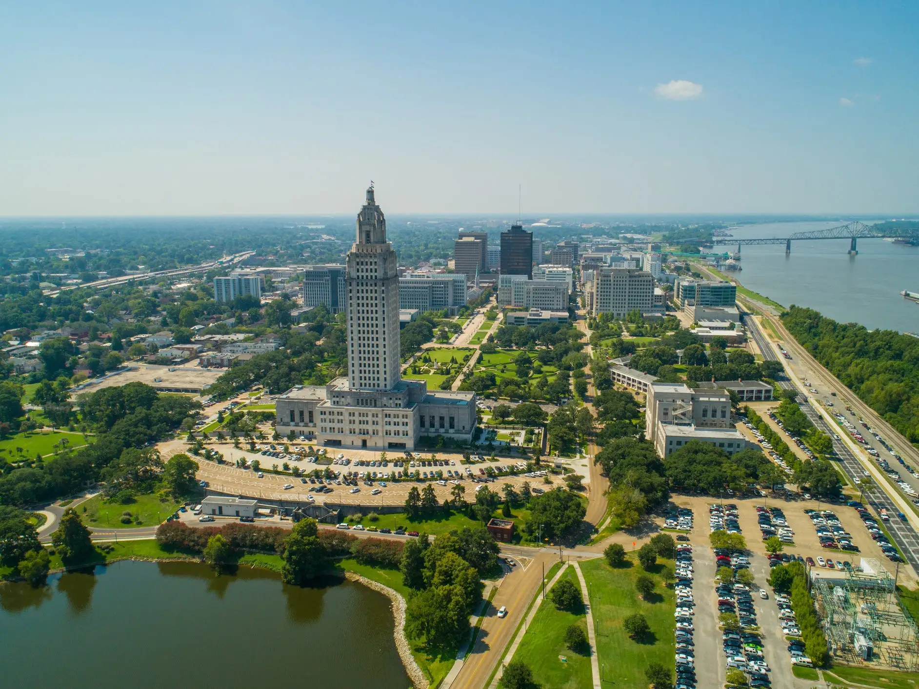 Aerial view of the Louisiana State Capitol, downtown Baton Rouge, and the Mississippi River on a clear day.