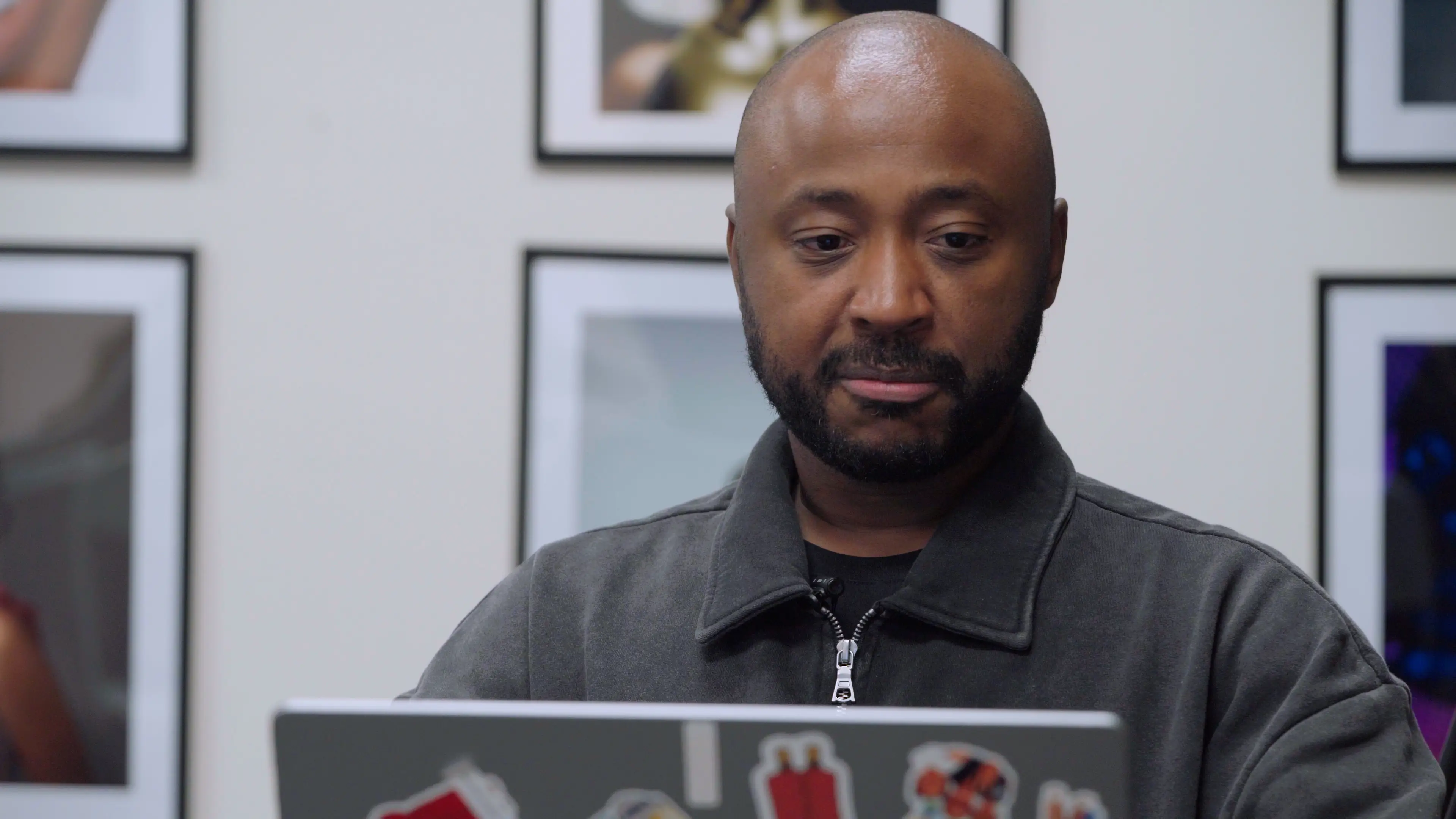Allen Cooley looks at his laptop covered in stickers.