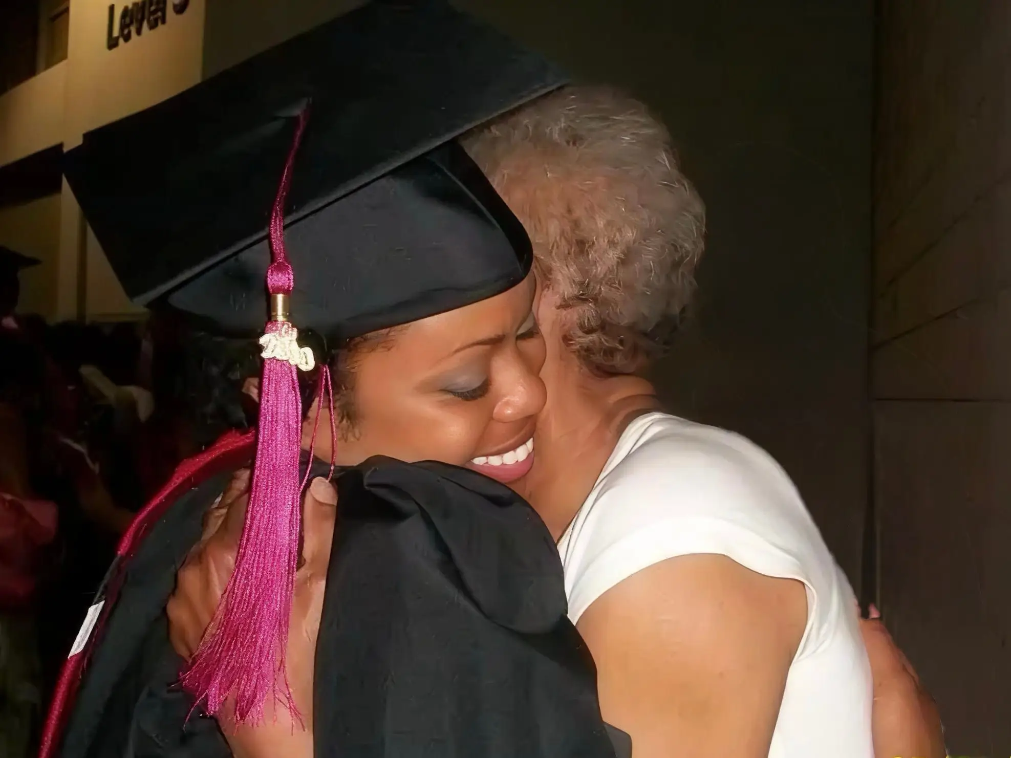 Chantel Henry embracing another person while wearing a graduation cap and gown