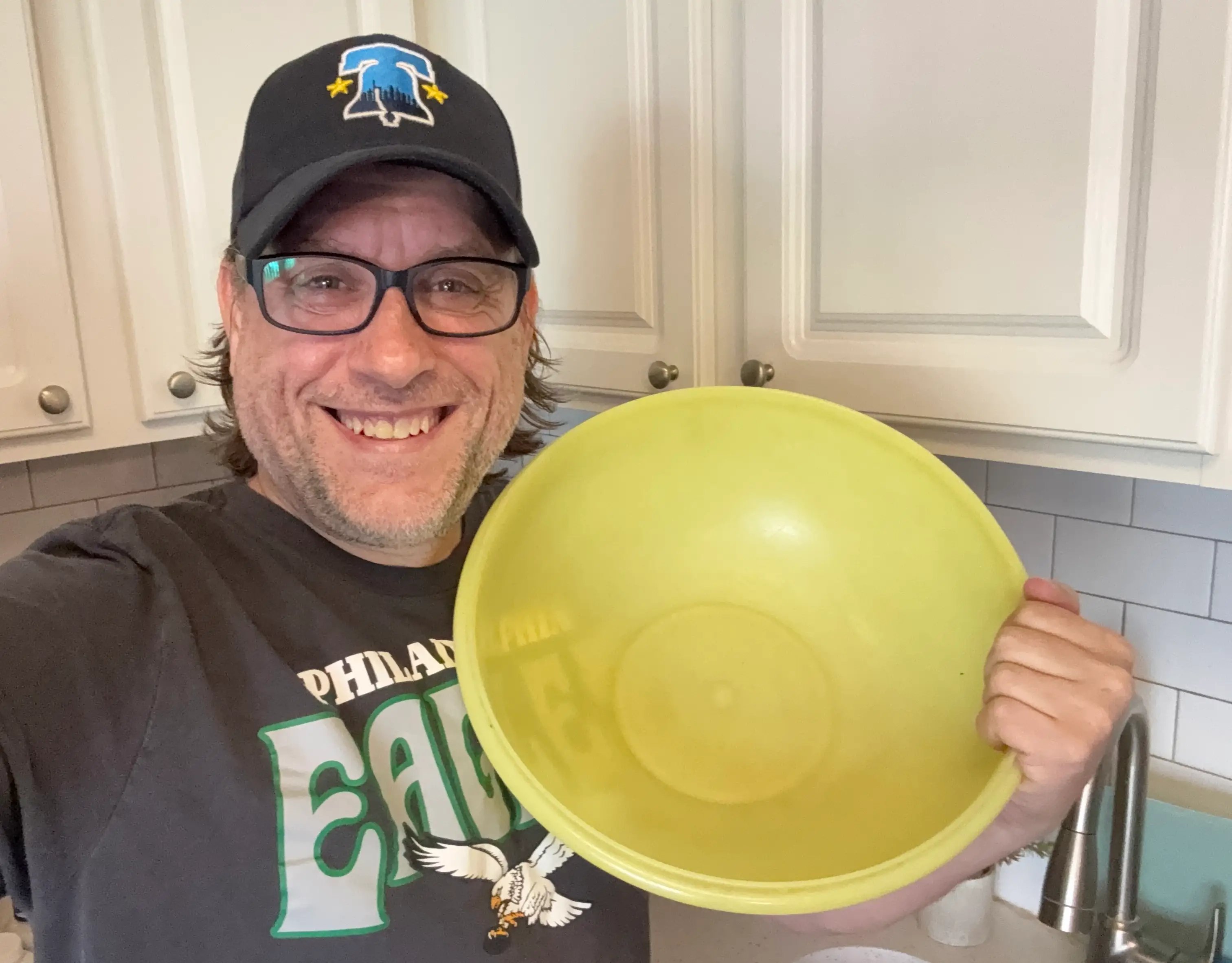 the author holding a tupperware bowl