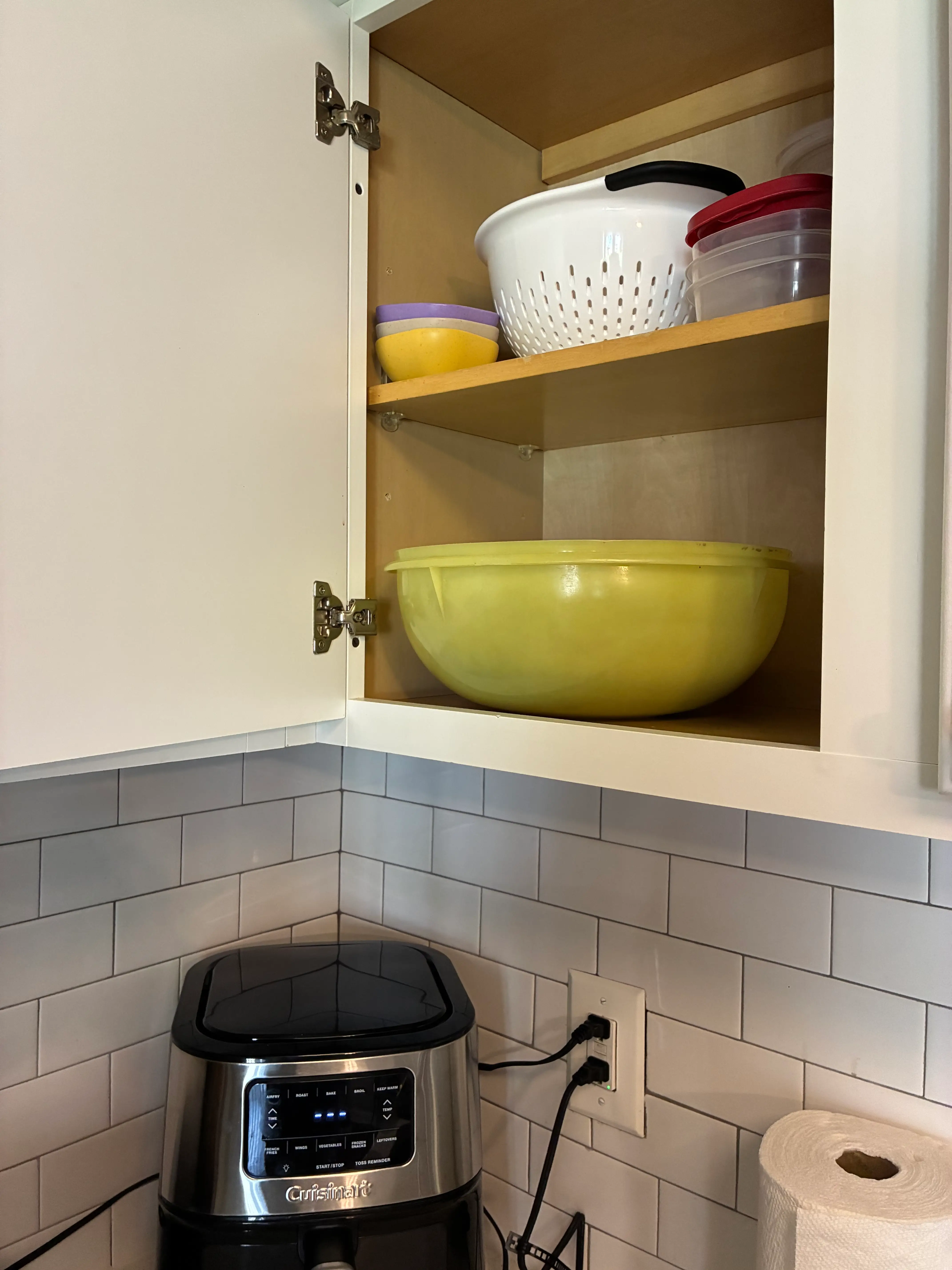 a tupperware bowl sticking out of a cabinet.
