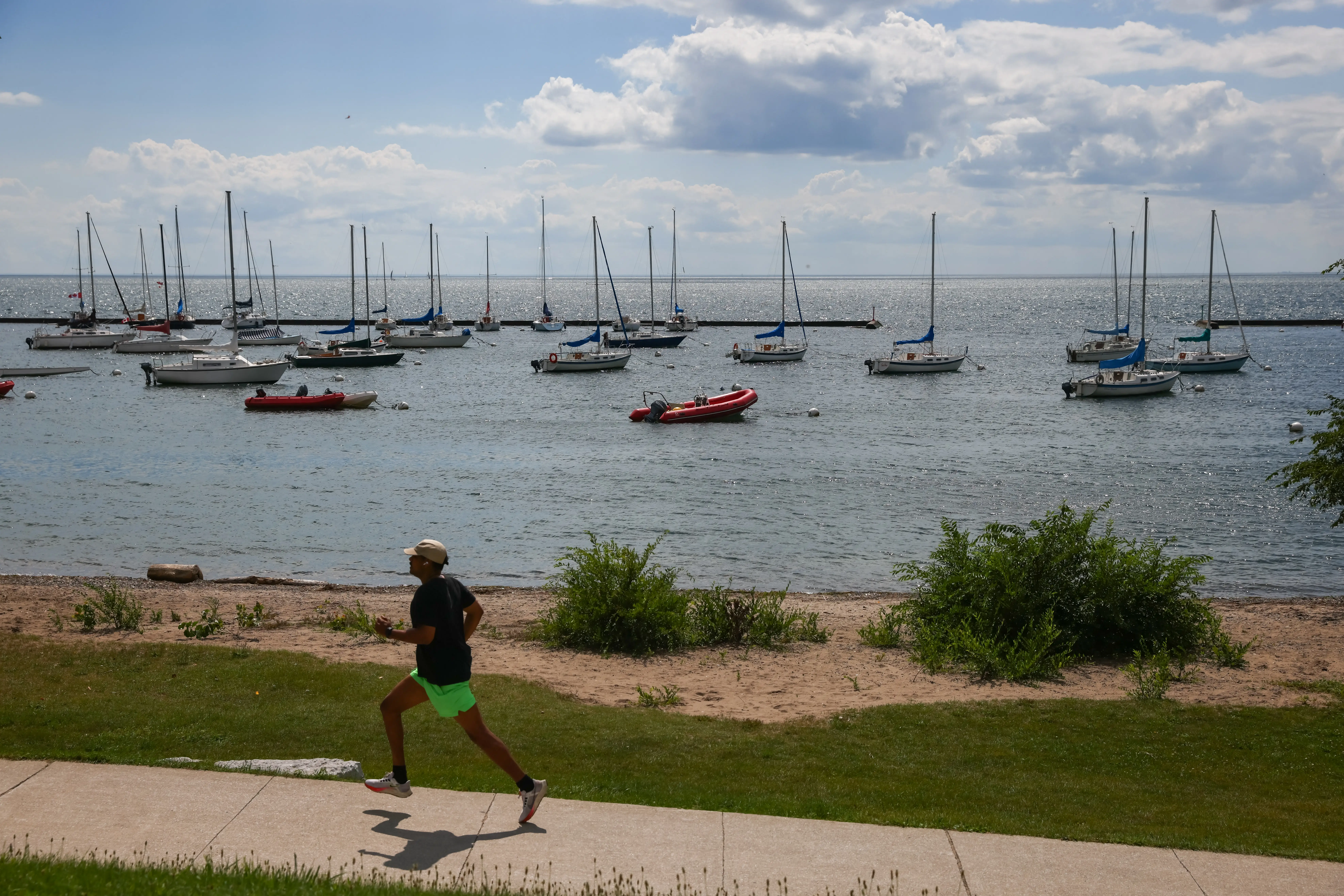 A jogger runs next to Lake Ontario