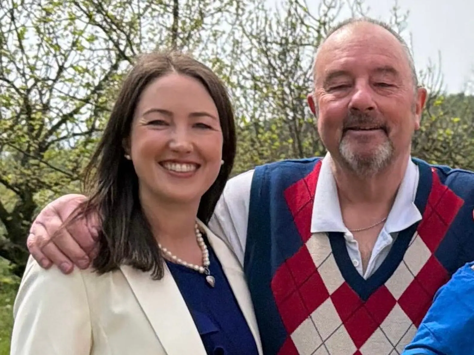 The author poses with her dad outside.