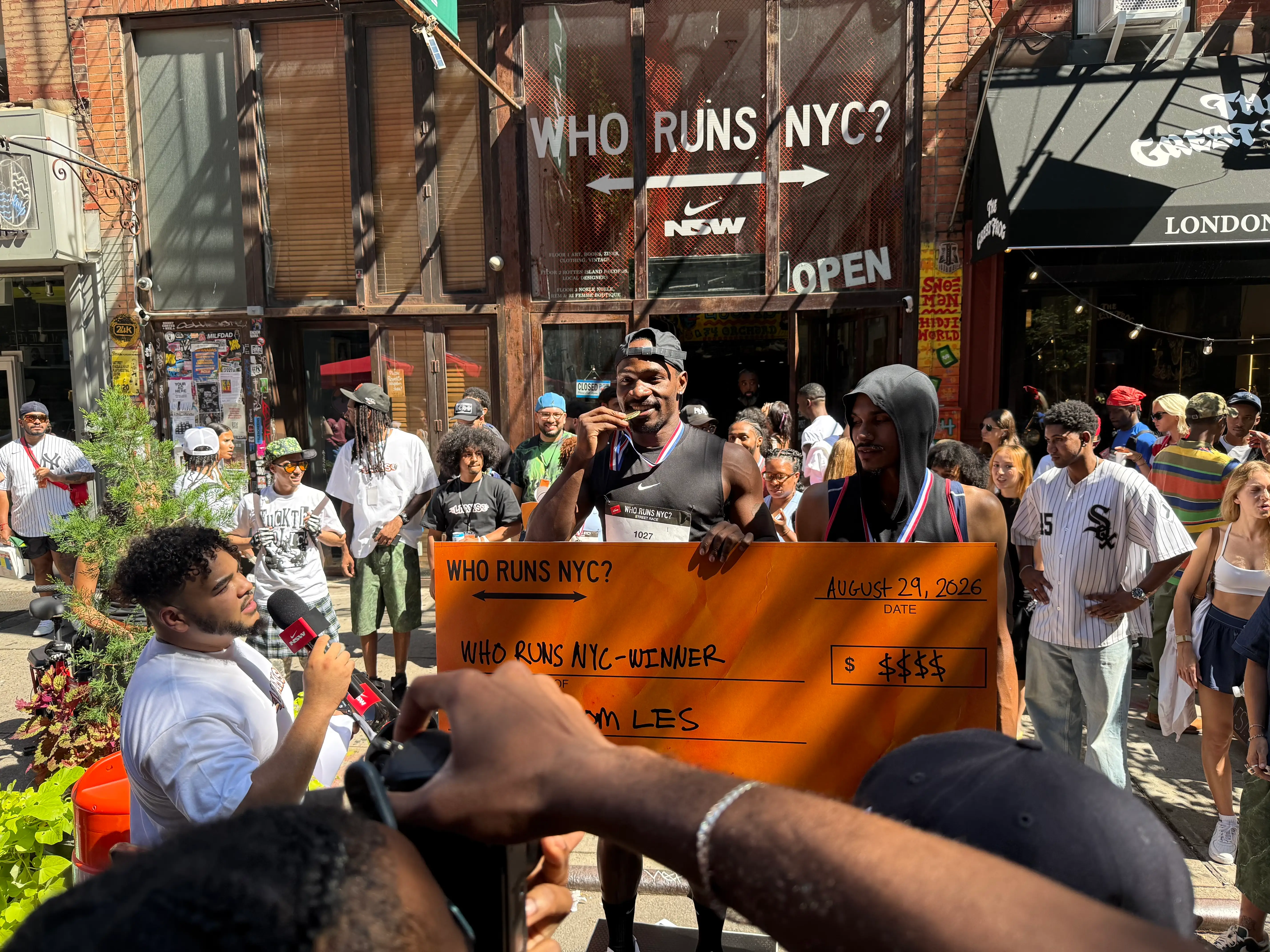 Akinola Raymond, 32, of Manhattan grinning at the podium on Saturday. Raymond said his rent was $3,800 per month.