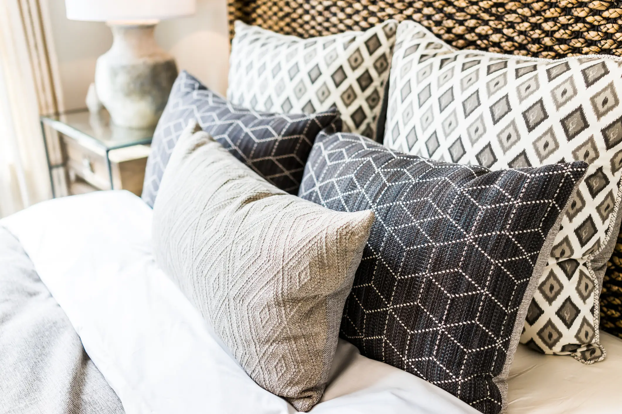 Five throw pillows on a bed