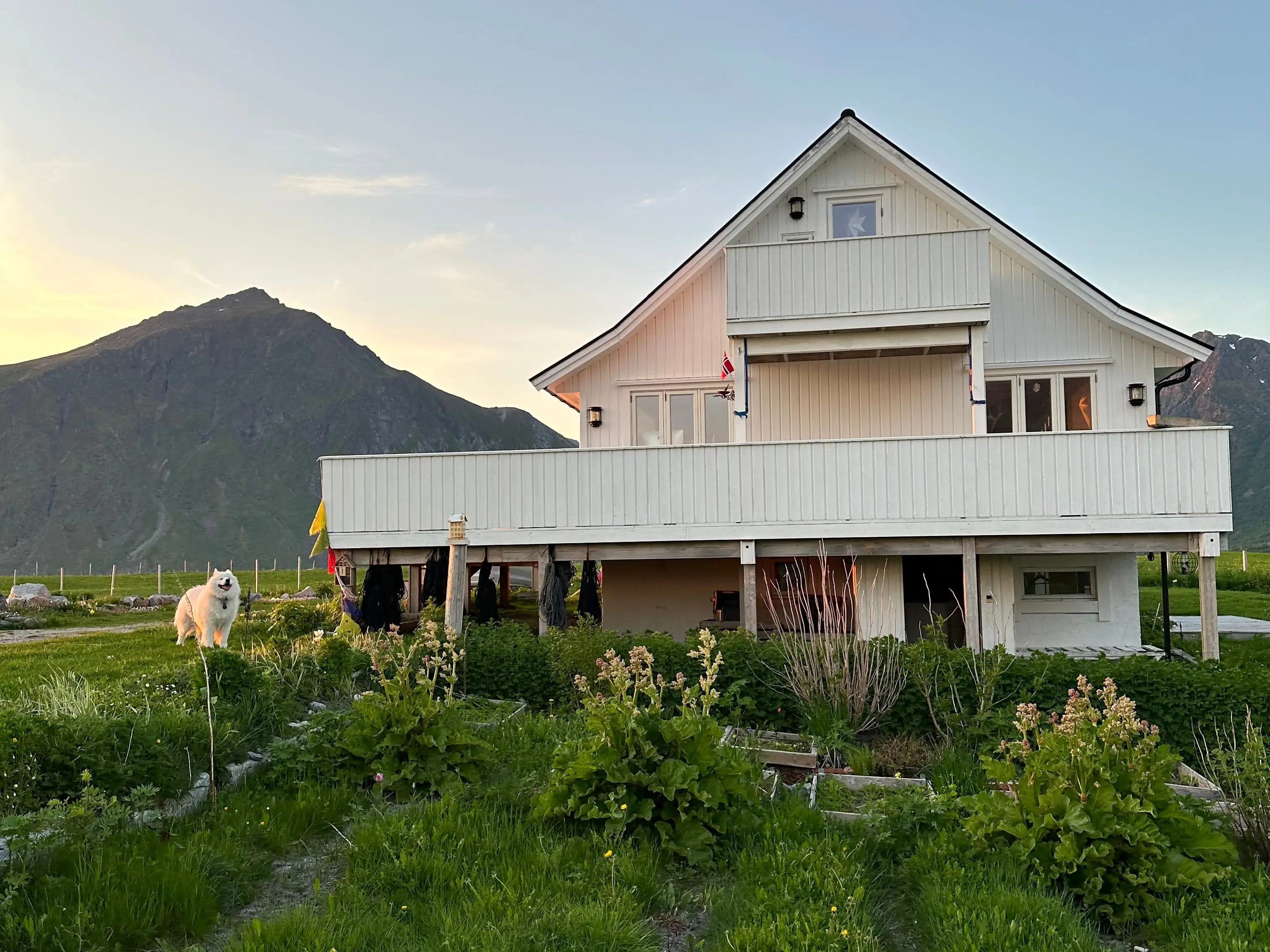 House surrounded by mountains, greenery