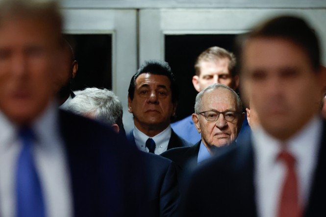 A man is seen behiind other men