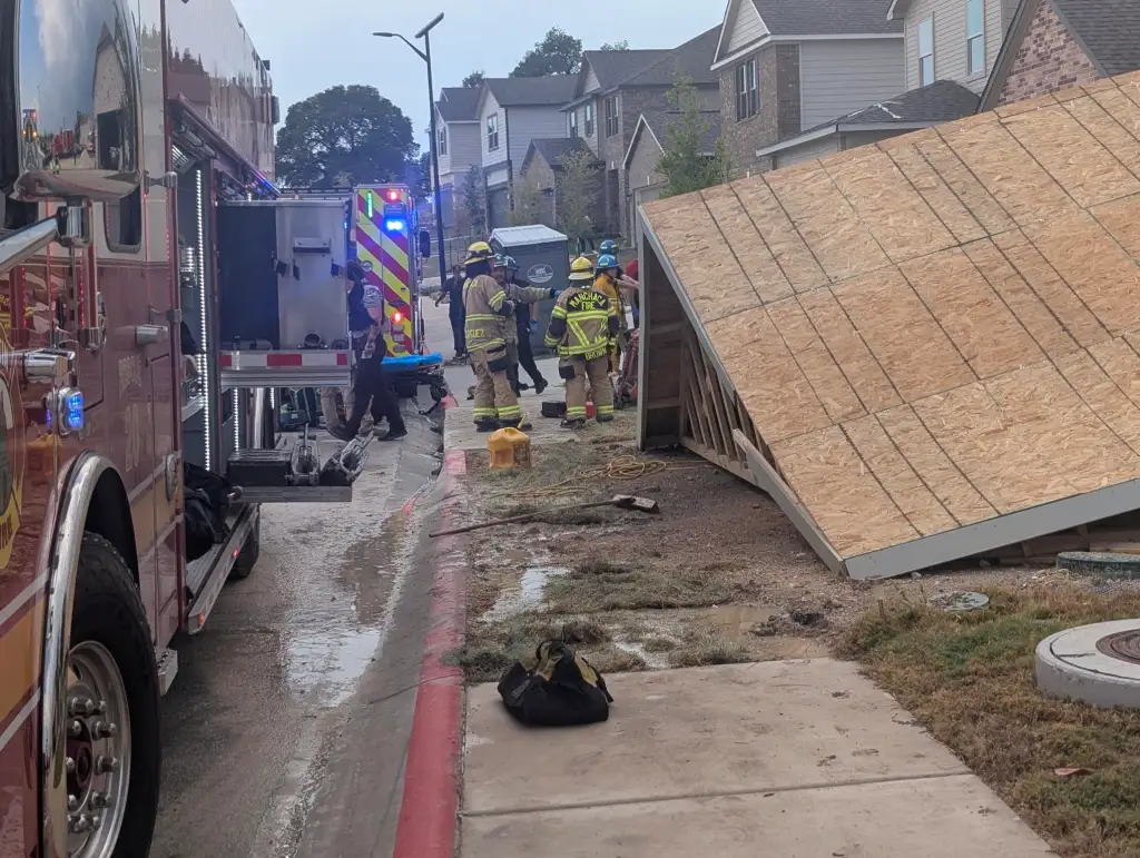 The entire two-story home collapsed, trapping two workers who couldn't escape.