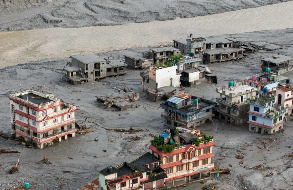 Over 500 people are dead and 1,500 missing after flash floods hit the Nepal-China border, as authorities warn of a new dam-burst threat.