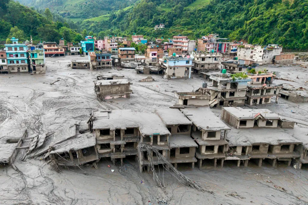 An aerial view shows houses lying deluged in sludge after flash floods at Devighat, Bidur Municipality in Nepal's Nuwakot district on Thursday.