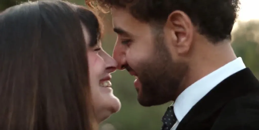 Mido and Debby from 90 Day Fiance facing each other and smiling.
