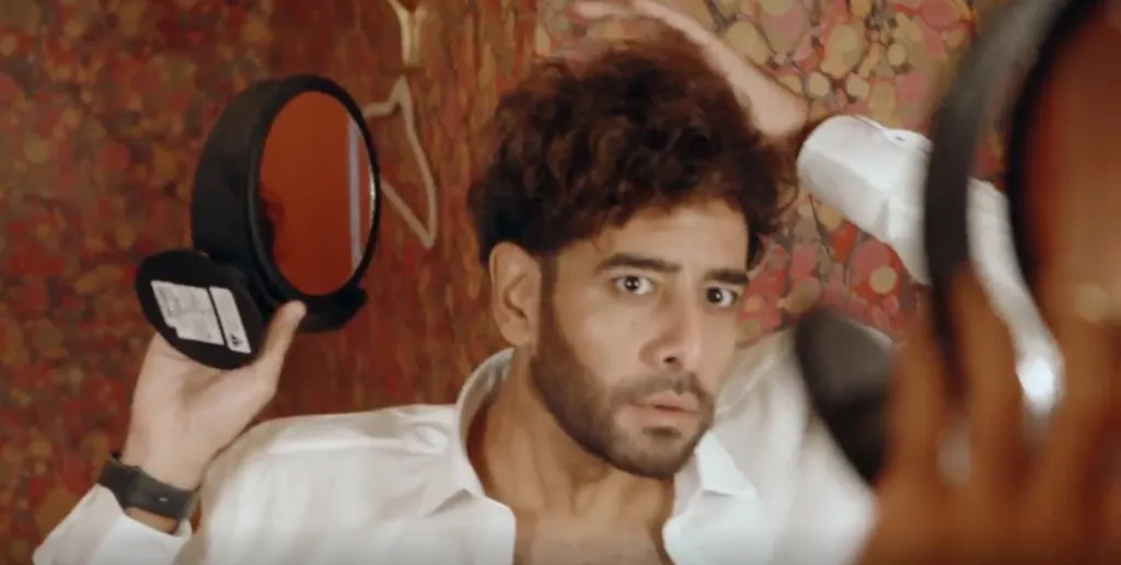 Mido looking at himself in a mirror, surprised.