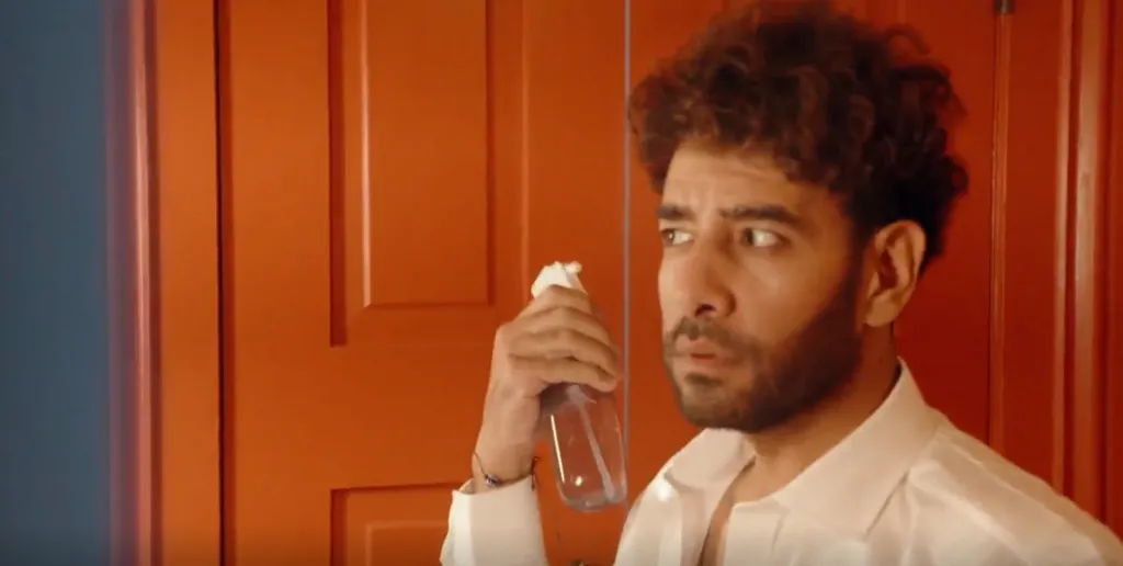Mido holding a spray bottle.