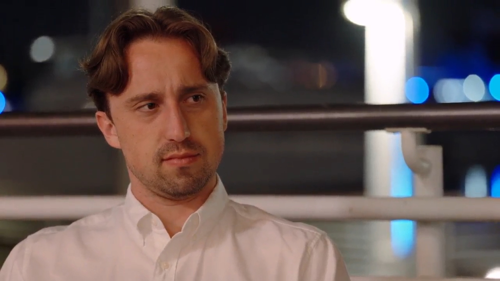 Thomas in a white shirt with a concerned expression.