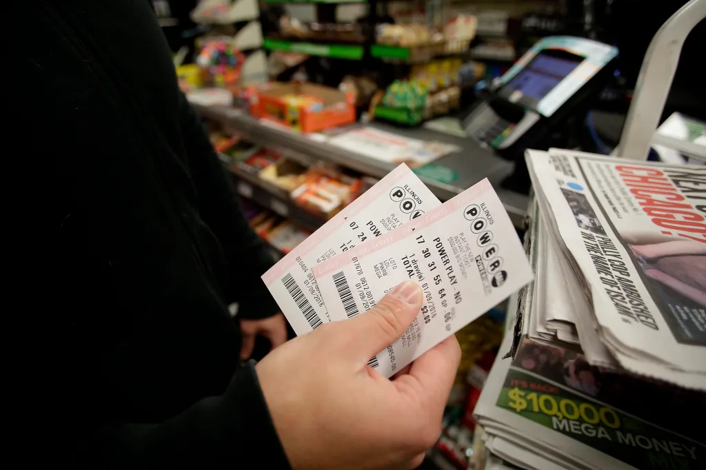A customer holding Powerball tickets at a 7-Eleven store.
