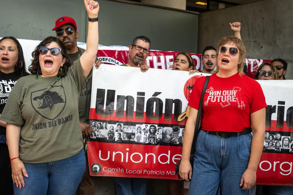 People holding a banner that says 