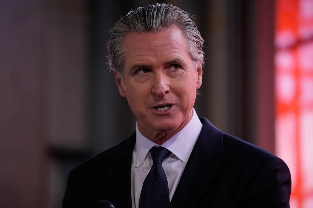 Gavin Newsom speaking at a podium.