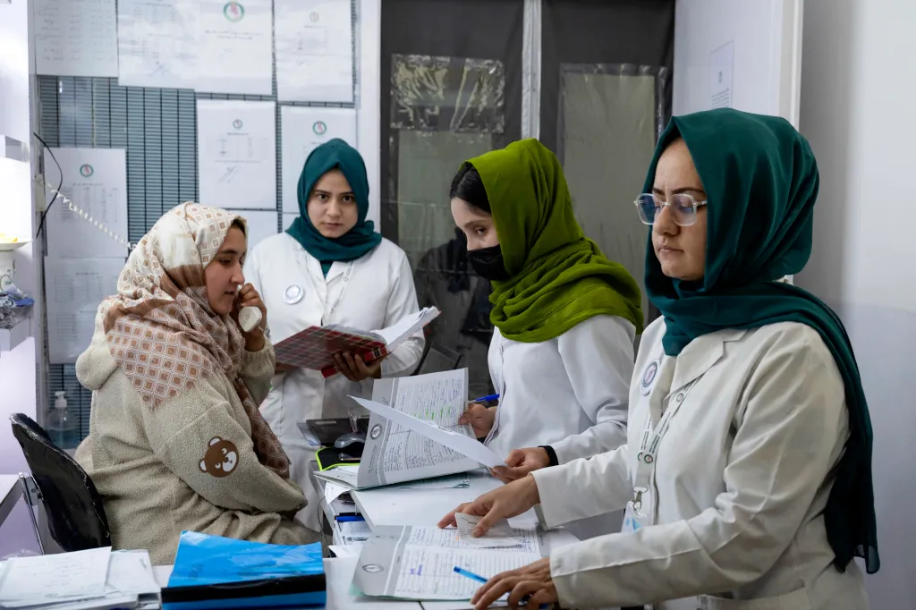 This photograph taken on December 10, 2024 shows Afghan female midwives and nurses checking the documents of pregnant women at a private hospital in Kabul